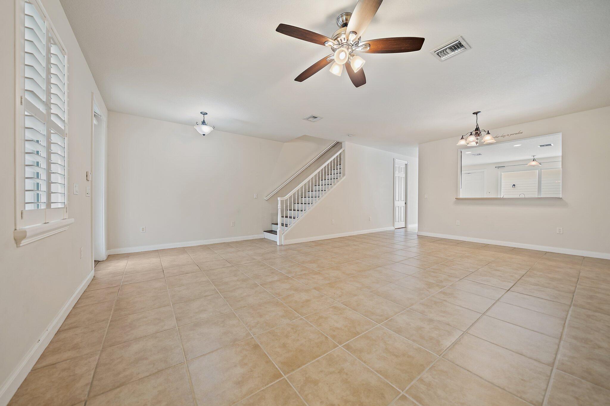 3253 Duncombe Drive Jupiter, FL 33458 - Photo 5 of 33 wooden floor in an empty room with a window