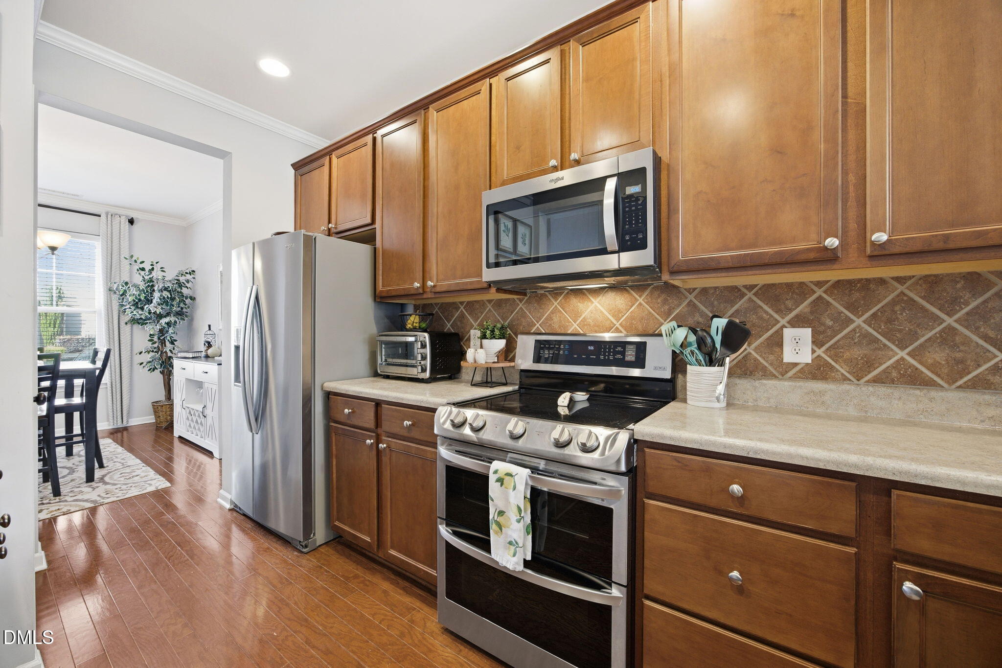 2827 Corbett Grove Drive Raleigh, NC 27616 - Photo 13 of 49 a kitchen with stainless steel appliances granite countertop a refrigerator stove and microwave