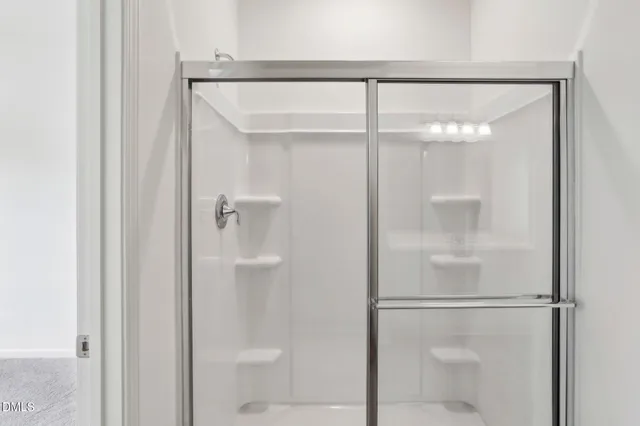 a bathroom with a glass shower door