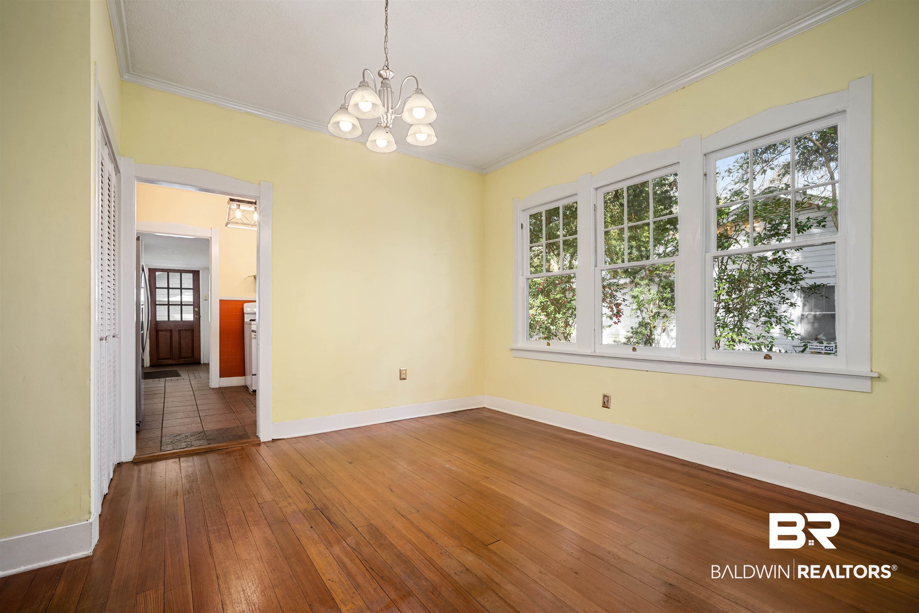 118 Mohawk Street Mobile, AL 36606 - Photo 10 of 26 Unfurnished dining area with ornamental molding, suspended lighting, and dark wood-type flooring