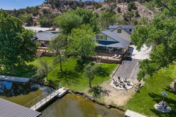 an aerial view of a house with a garden and lake view