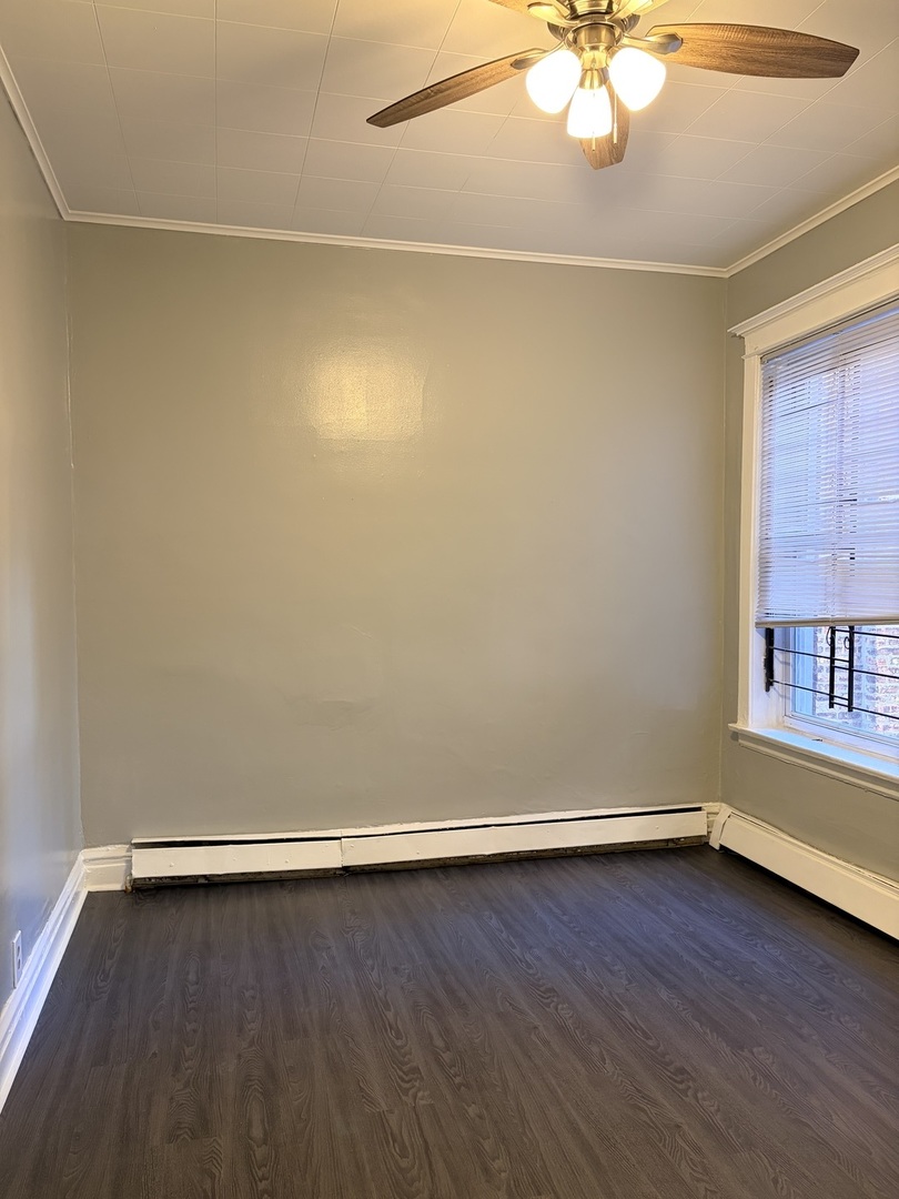 7700 South Green Street, Unit 1 Chicago, IL 60620 - Photo 7 of 11 a view of a room with wooden floor and fan