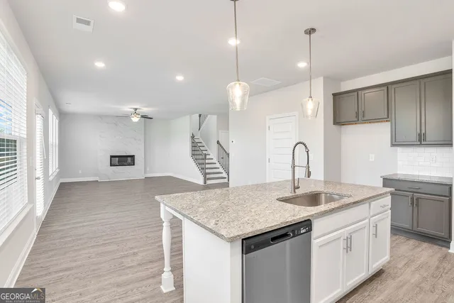 a kitchen with sink refrigerator and cabinets