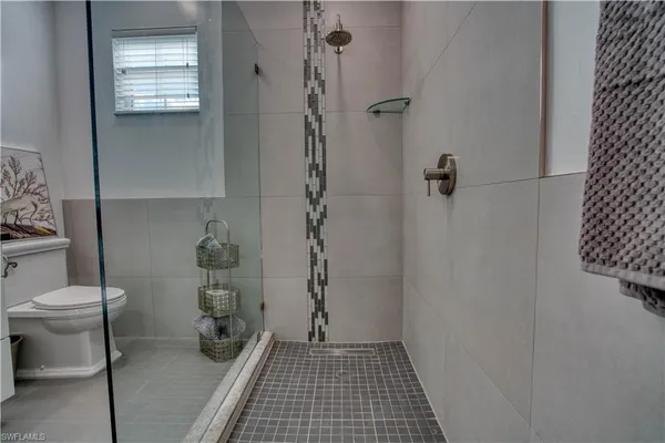 a bathroom with a toilet and a shower