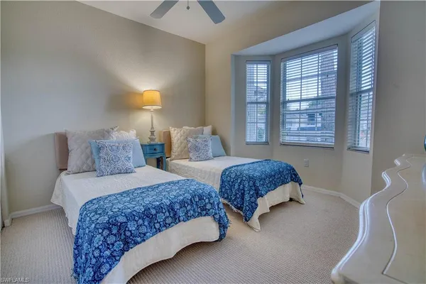 a bedroom with two beds and a window