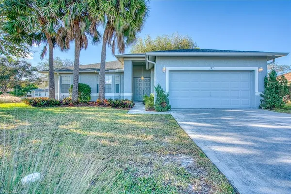a front view of house with yard and green space