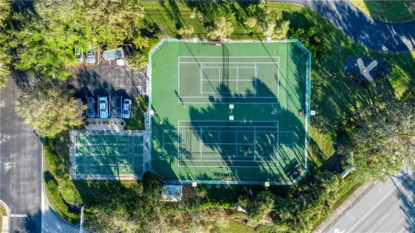 a green field with lots of trees