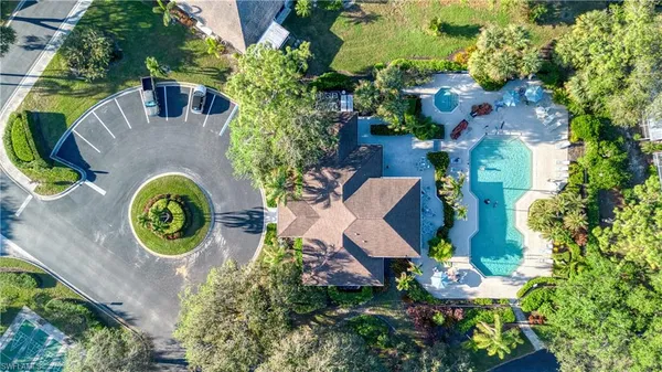 an aerial view of a house with outdoor space and tennis court