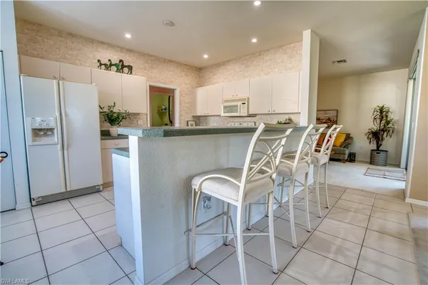 a kitchen with stainless steel appliances a refrigerator sink and cabinets