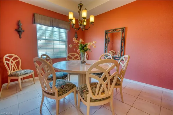 a view of a dining room with furniture and chandelier
