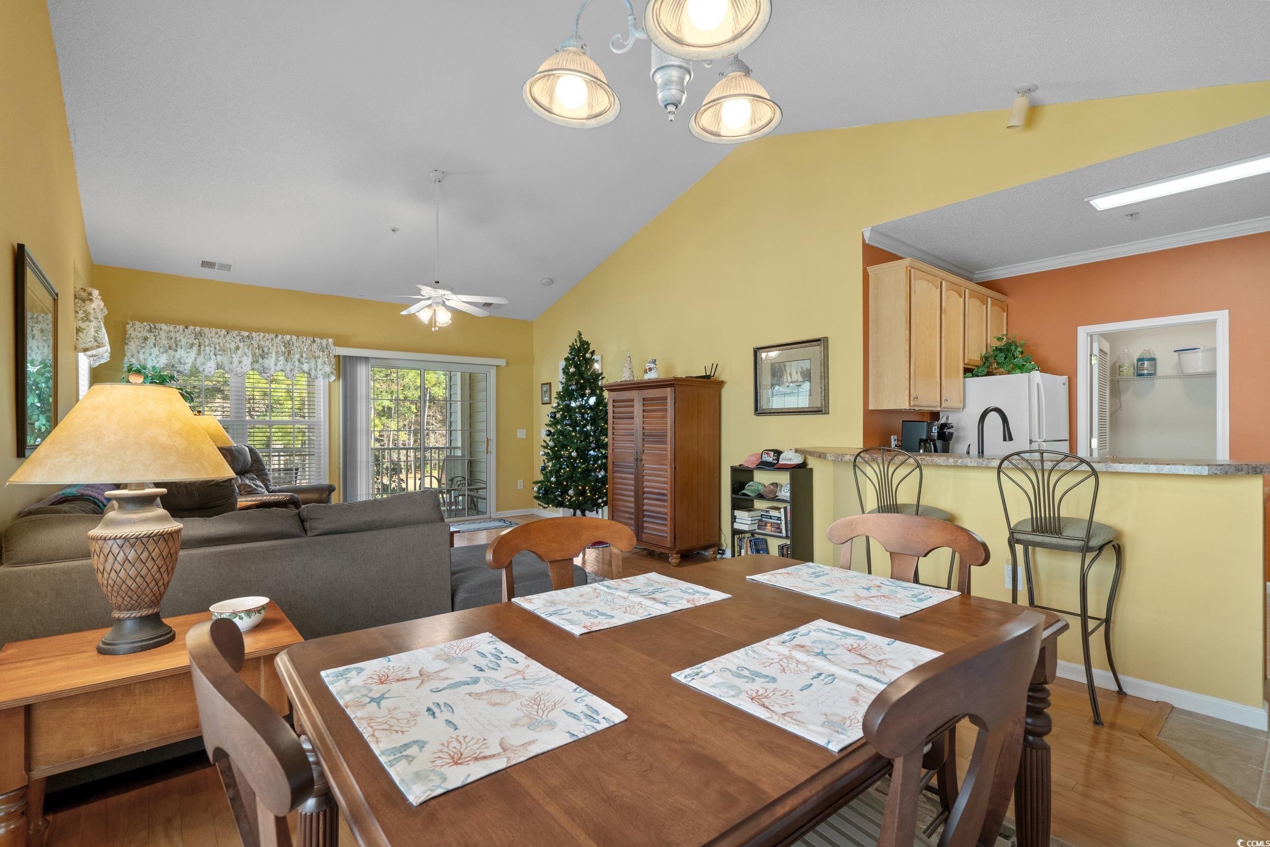 5852 Longwood Drive, Unit 301 Murrells Inlet, SC 29576 - Photo 12 of 35 Dining area featuring lofted ceiling, light wood finished floors, and ceiling fan