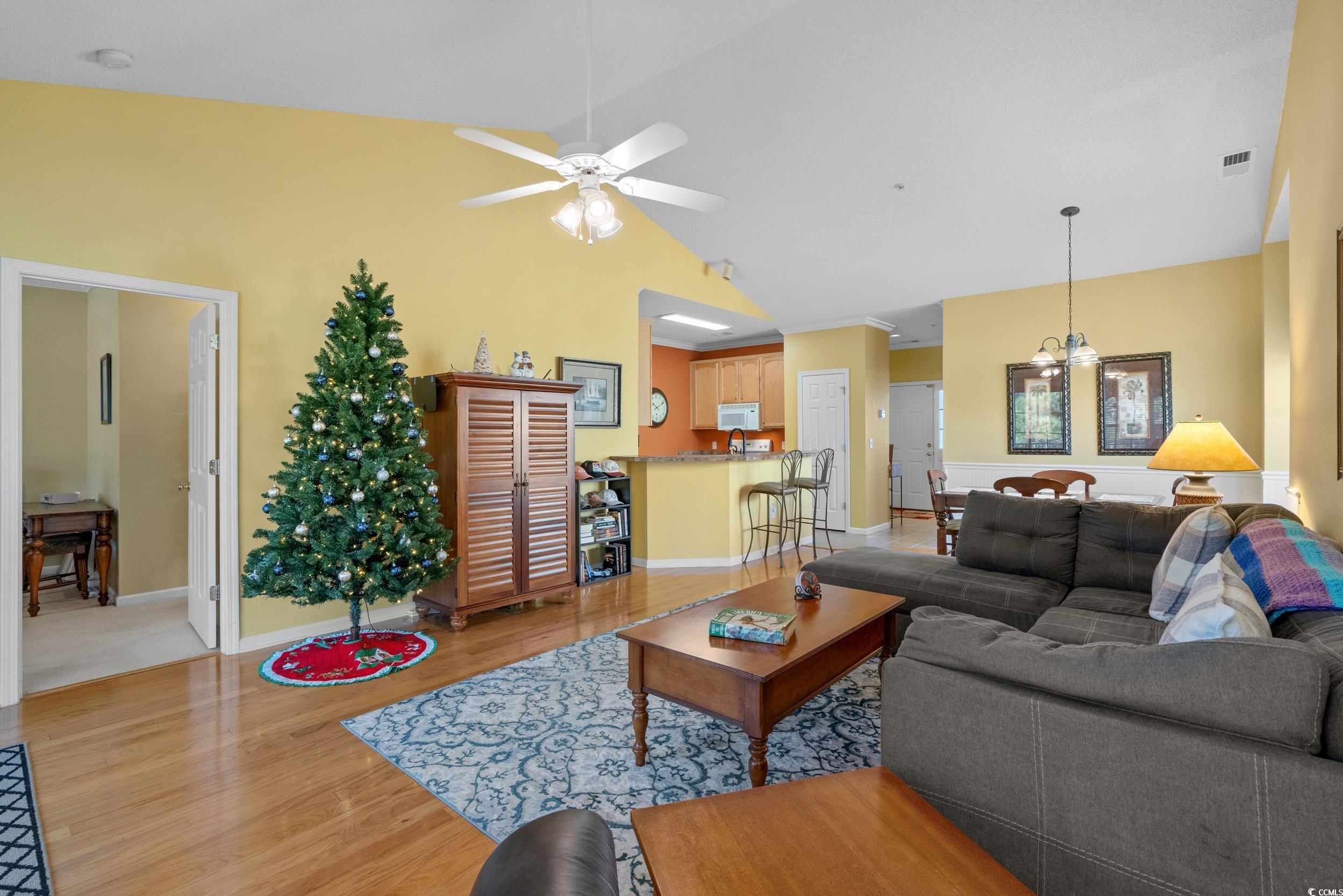 5852 Longwood Drive, Unit 301 Murrells Inlet, SC 29576 - Photo 14 of 35 Living area with light wood-type flooring, ceiling fan, and high vaulted ceiling