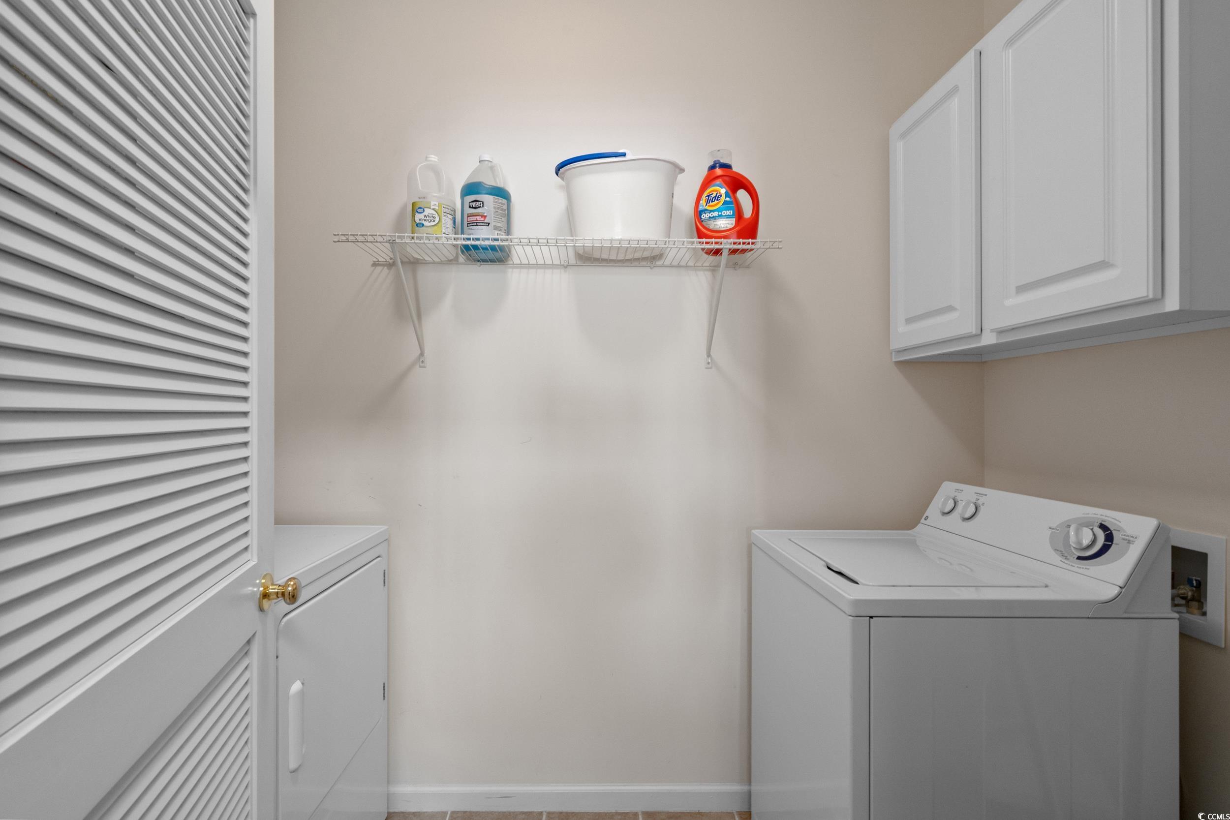 5852 Longwood Drive, Unit 301 Murrells Inlet, SC 29576 - Photo 18 of 35 Washroom with cabinet space and washer and dryer