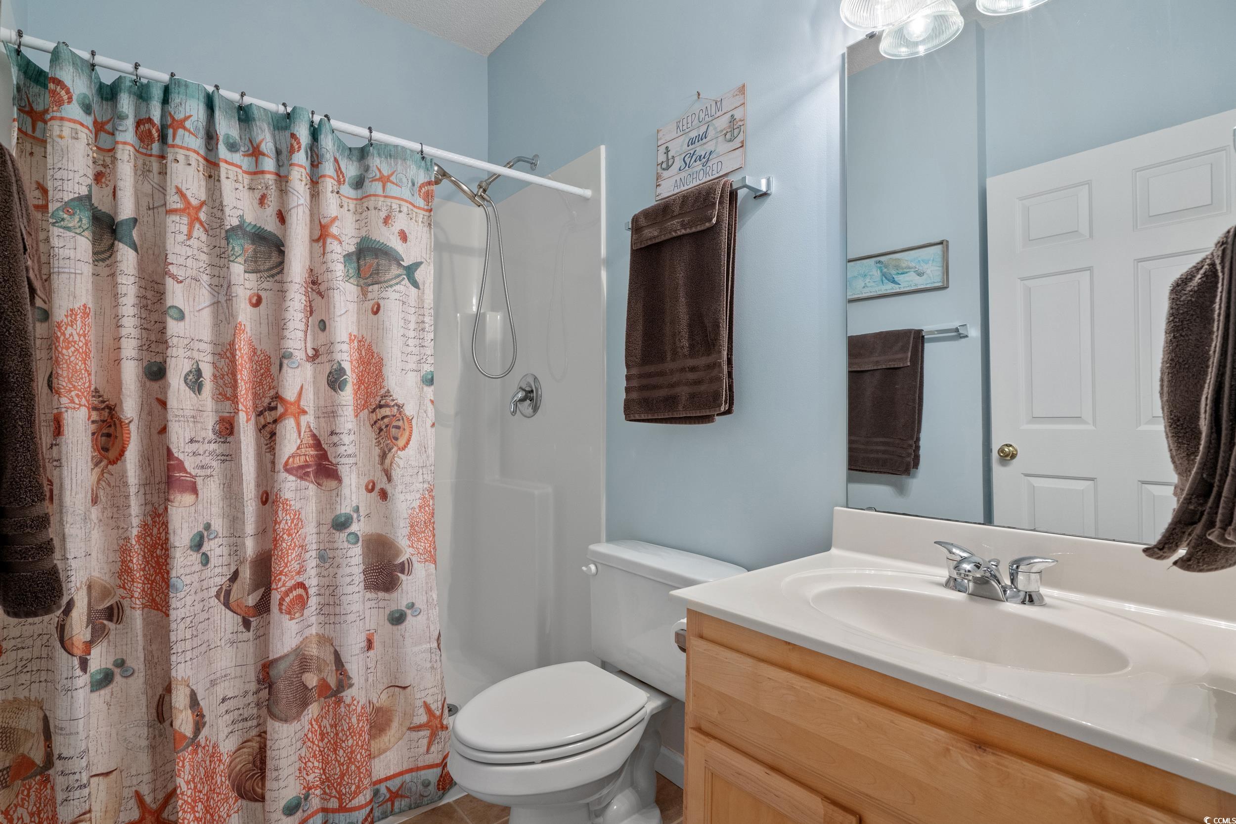 5852 Longwood Drive, Unit 301 Murrells Inlet, SC 29576 - Photo 19 of 35 Bathroom with vanity and a shower with shower curtain