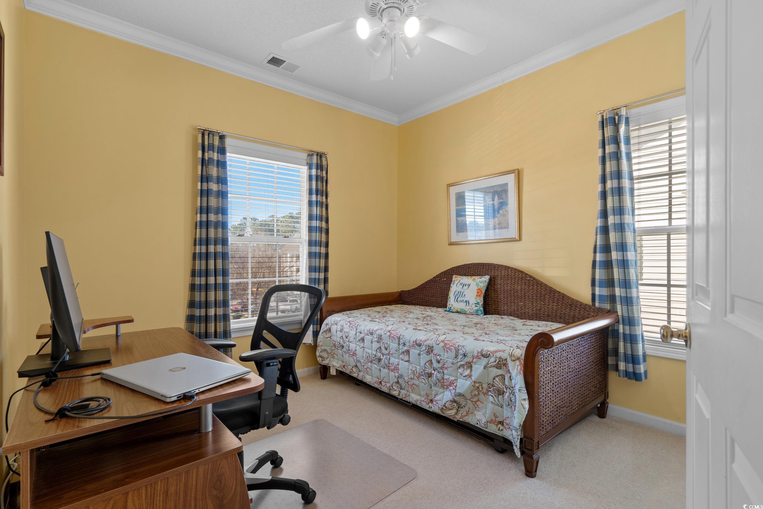 5852 Longwood Drive, Unit 301 Murrells Inlet, SC 29576 - Photo 21 of 35 Bedroom featuring ornamental molding, a ceiling fan, light carpet, and an office area