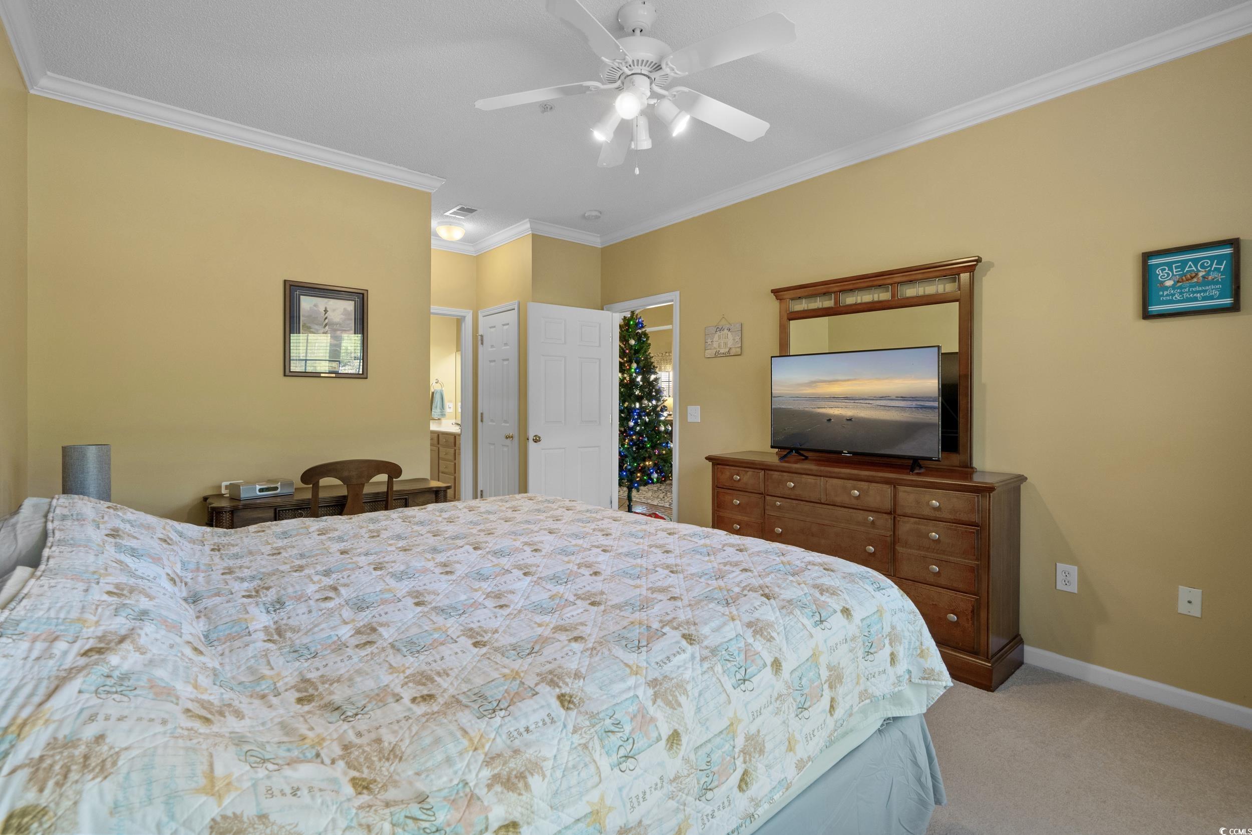 5852 Longwood Drive, Unit 301 Murrells Inlet, SC 29576 - Photo 25 of 35 Bedroom featuring crown molding, light carpet, and a ceiling fan