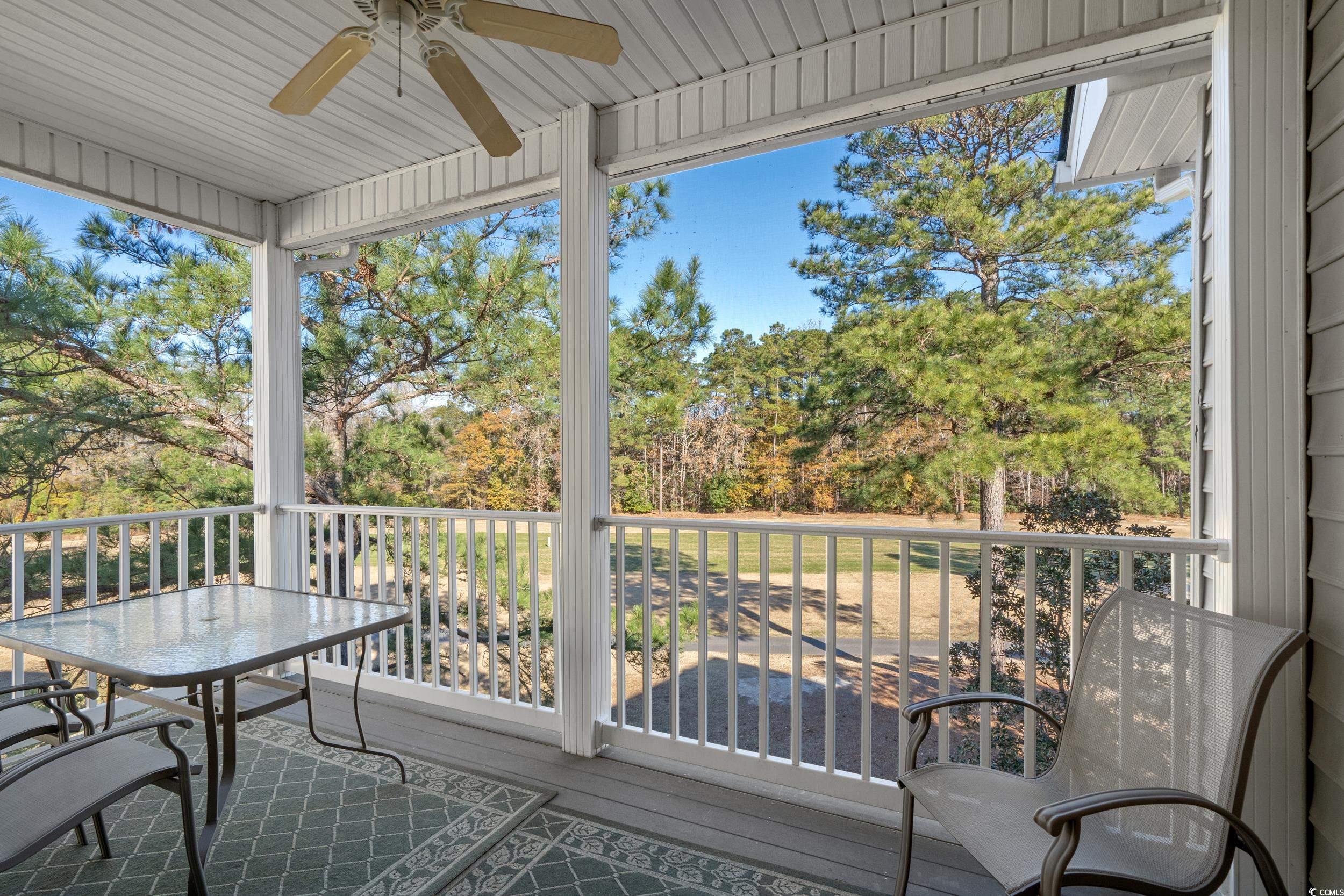 5852 Longwood Drive, Unit 301 Murrells Inlet, SC 29576 - Photo 26 of 35 Balcony featuring a ceiling fan, view of wooded area, and a sunroom
