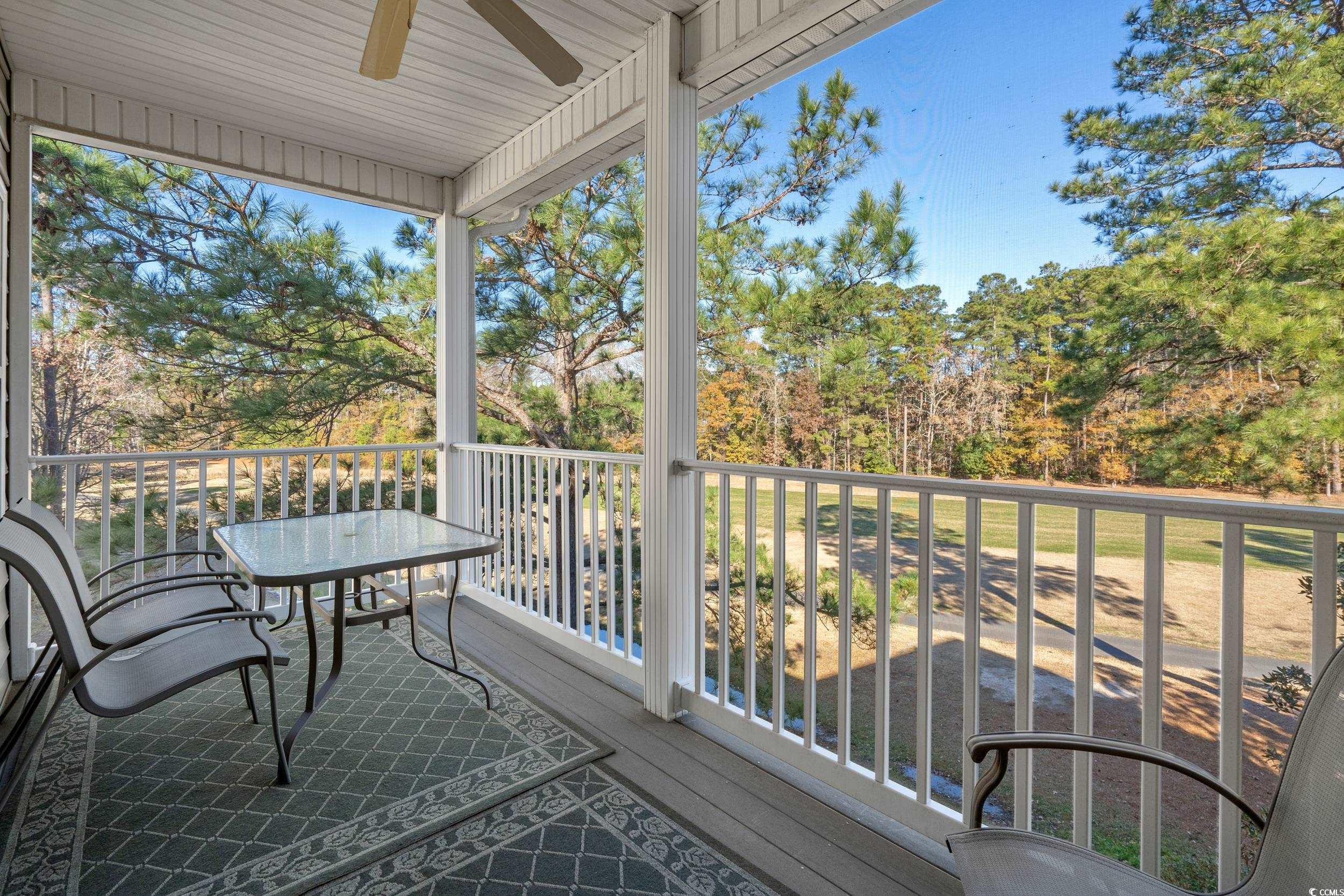 5852 Longwood Drive, Unit 301 Murrells Inlet, SC 29576 - Photo 3 of 35 Balcony with ceiling fan and view of wooded area