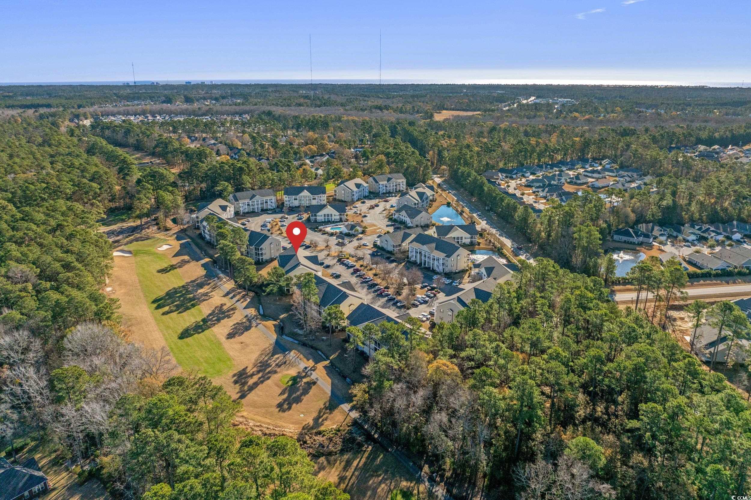 5852 Longwood Drive, Unit 301 Murrells Inlet, SC 29576 - Photo 32 of 35 Aerial overview of property's location with a heavily wooded area and nearby suburban area