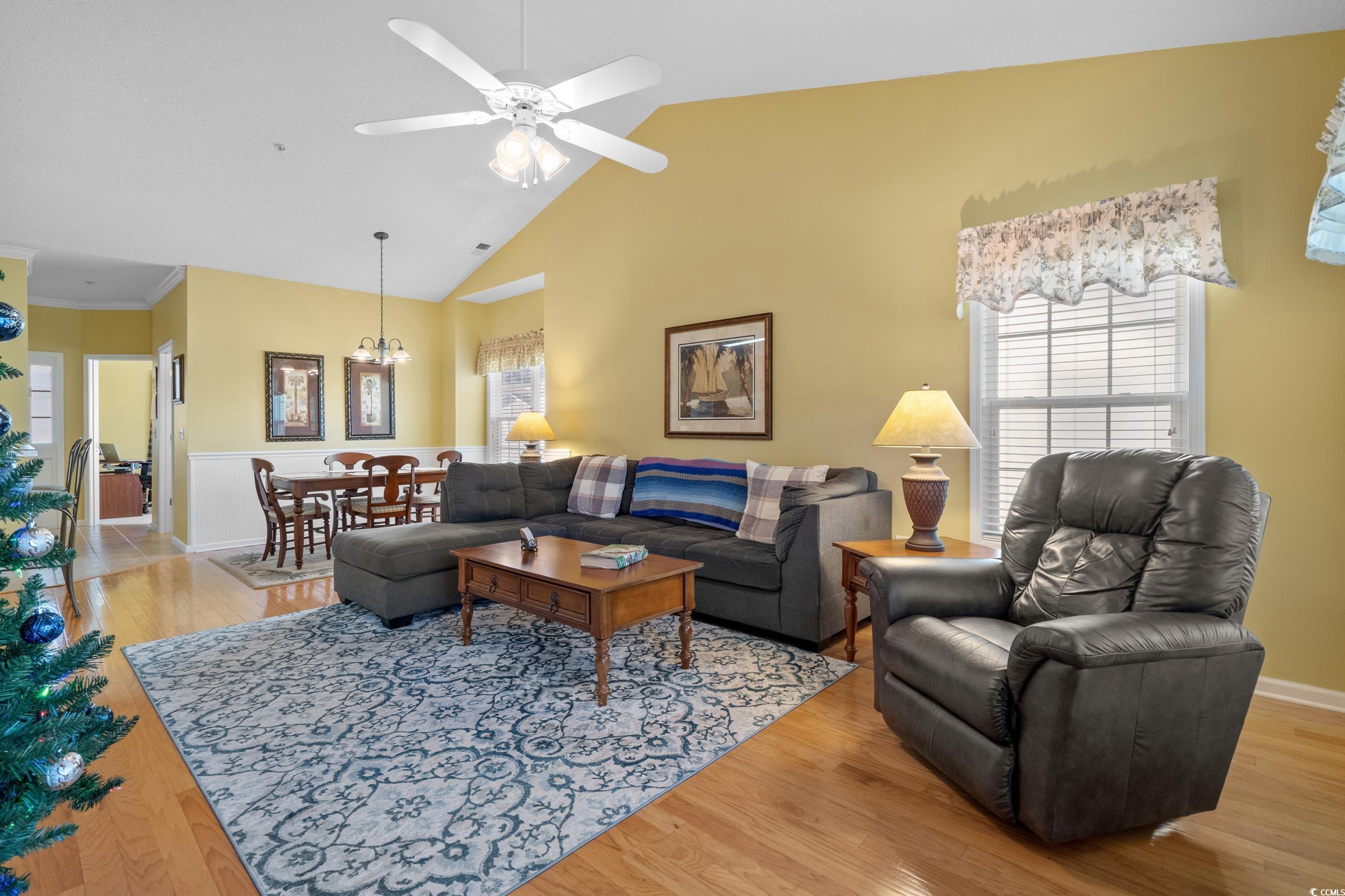 5852 Longwood Drive, Unit 301 Murrells Inlet, SC 29576 - Photo 4 of 35 Living area with light wood-type flooring, high vaulted ceiling, a ceiling fan, and a chandelier
