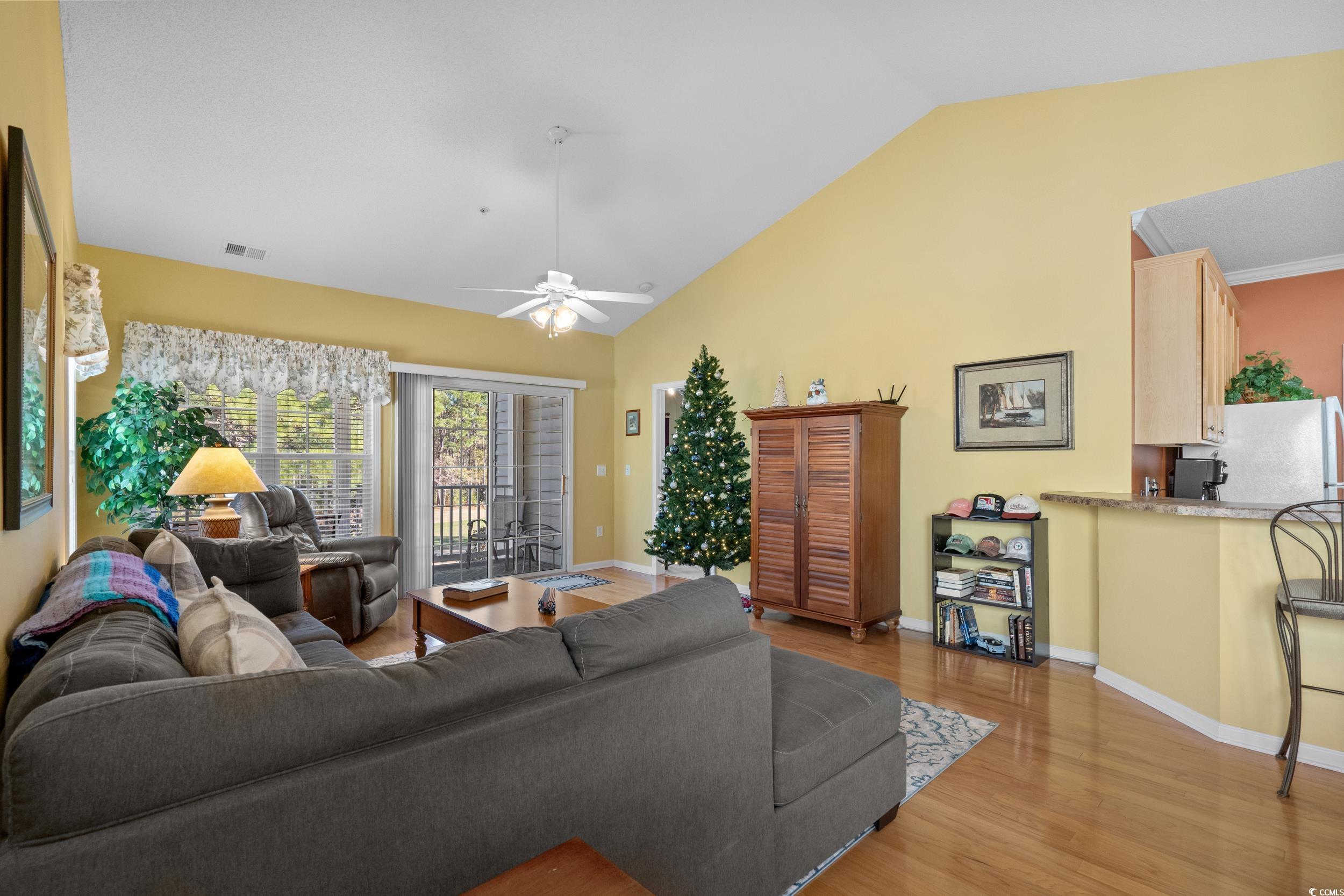 5852 Longwood Drive, Unit 301 Murrells Inlet, SC 29576 - Photo 9 of 35 Living area with wood finished floors, ceiling fan, and high vaulted ceiling