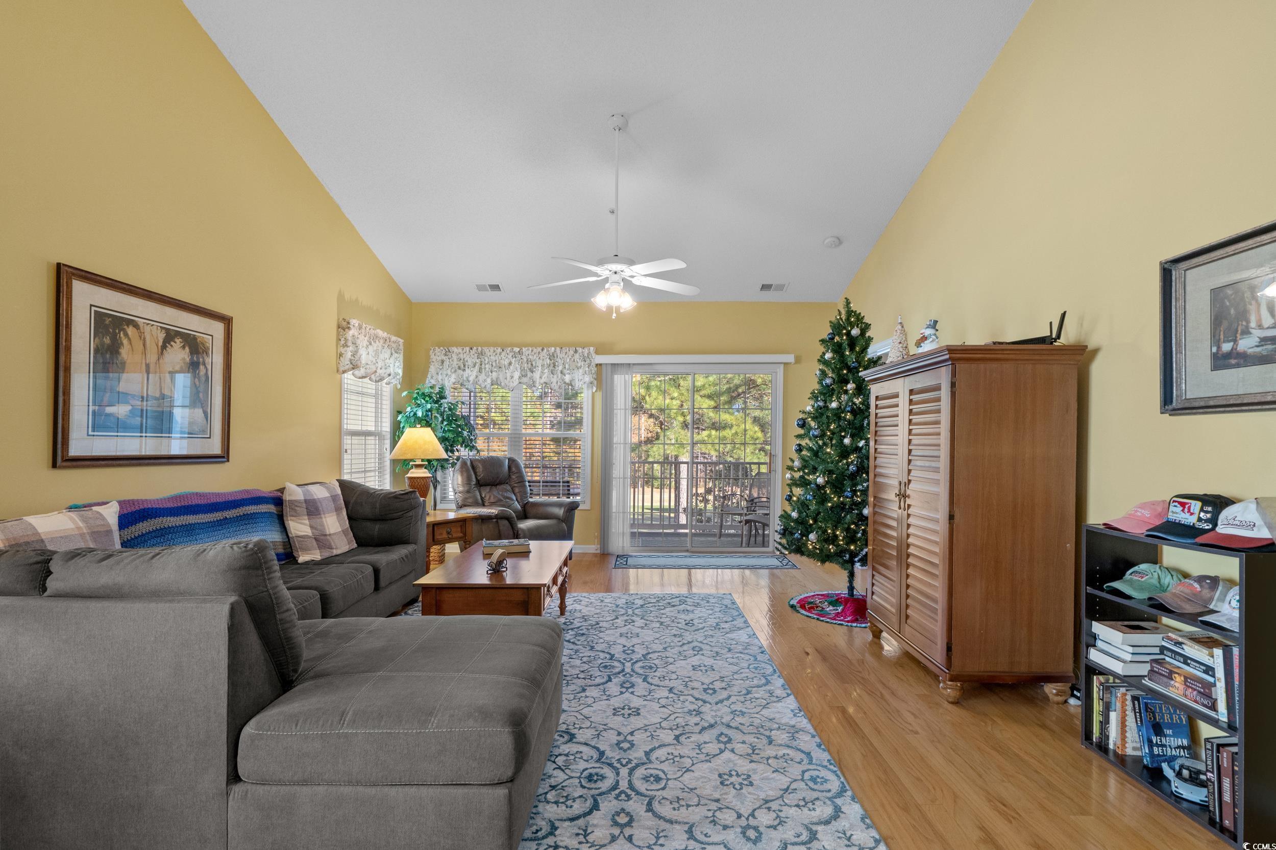 5852 Longwood Drive, Unit 301 Murrells Inlet, SC 29576 - Photo 10 of 35 Living area featuring light wood-type flooring, high vaulted ceiling, and ceiling fan