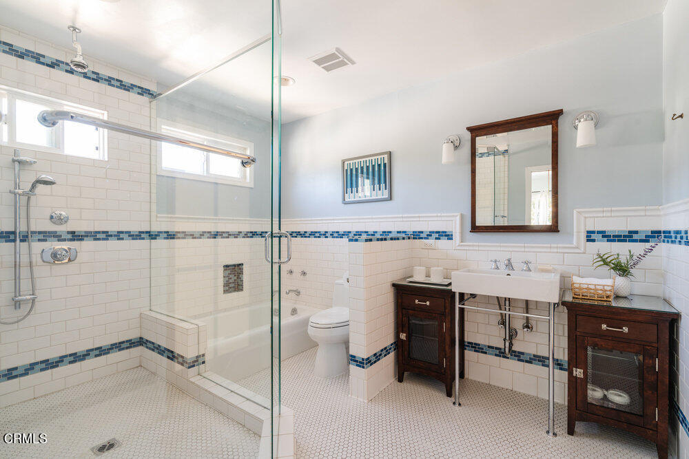 2089 Mar Vista Avenue Altadena, CA 91001 - Photo 24 of 32 a spacious bathroom with a double vanity sink a toilet and a mirror