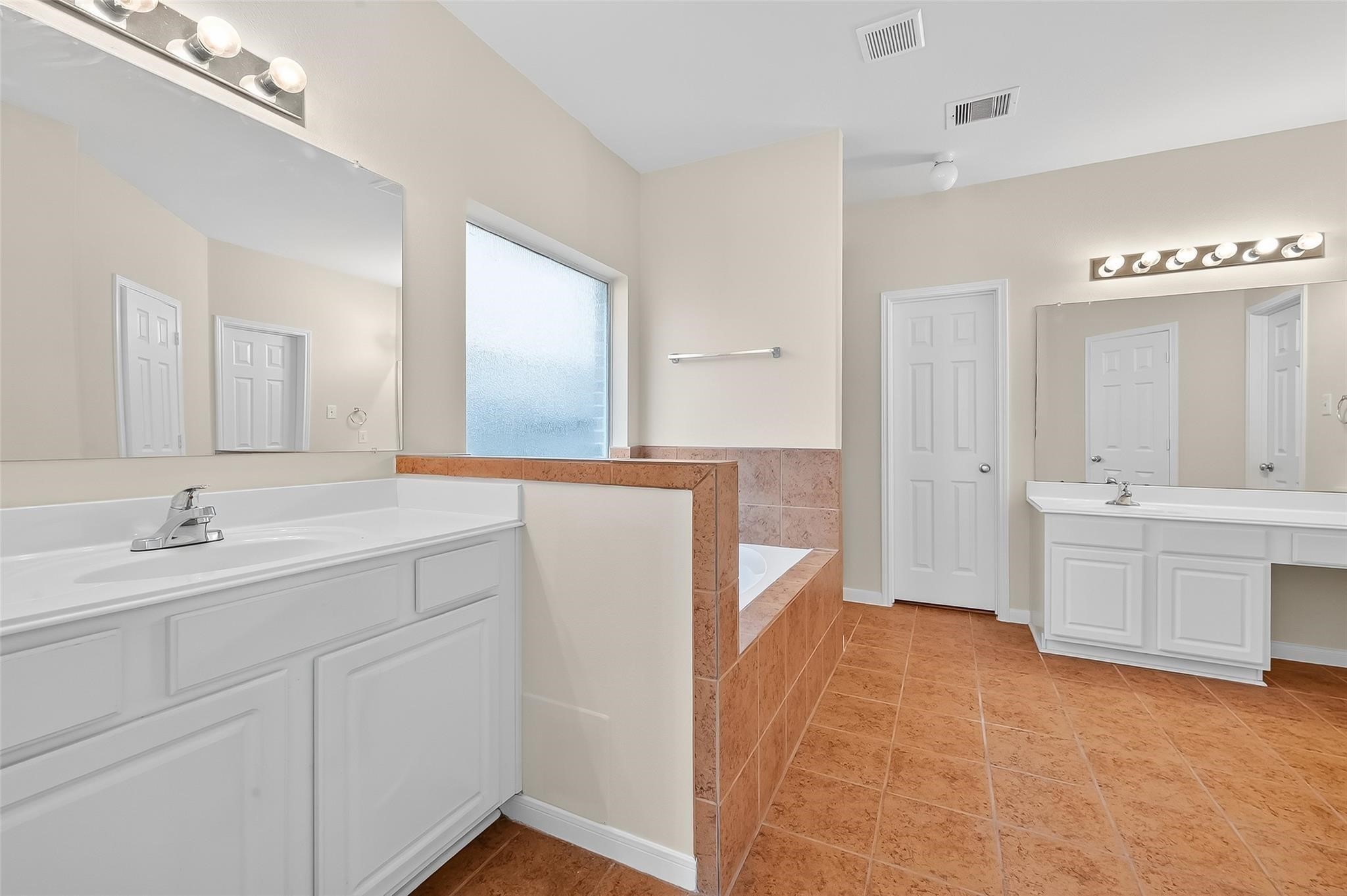 21623 Mid Peak Way Katy, TX 77449 - Photo 17 of 38 a spacious bathroom with a bathtub sink and mirror
