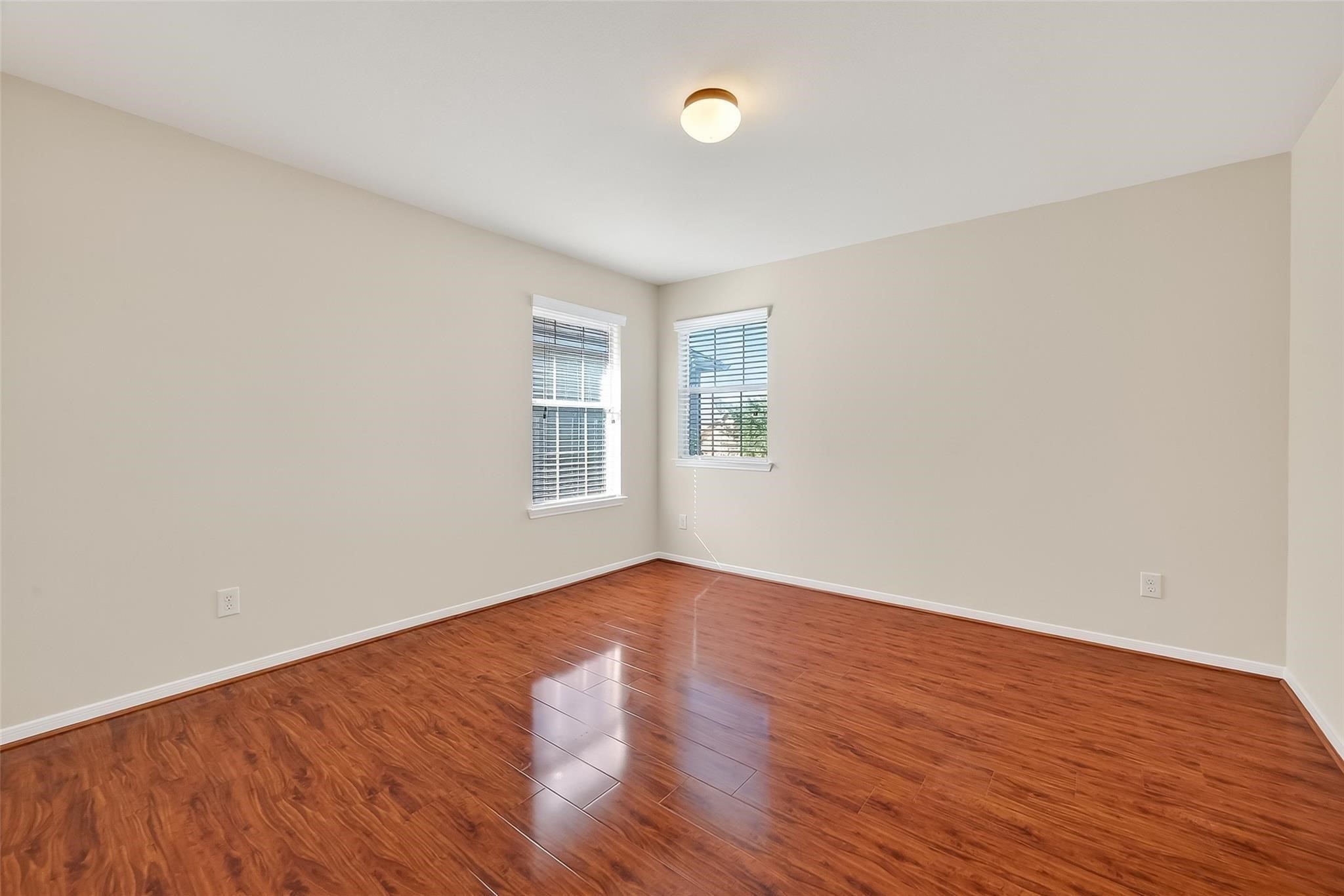 21623 Mid Peak Way Katy, TX 77449 - Photo 25 of 38 an empty room with wooden floor and windows