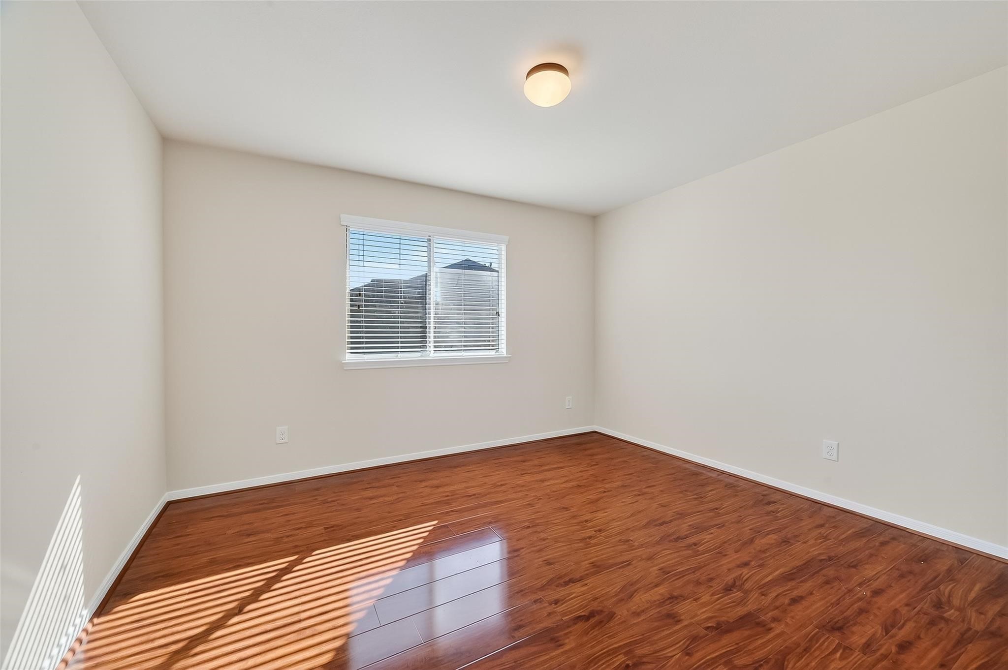 21623 Mid Peak Way Katy, TX 77449 - Photo 28 of 38 an empty room with wooden floor and windows