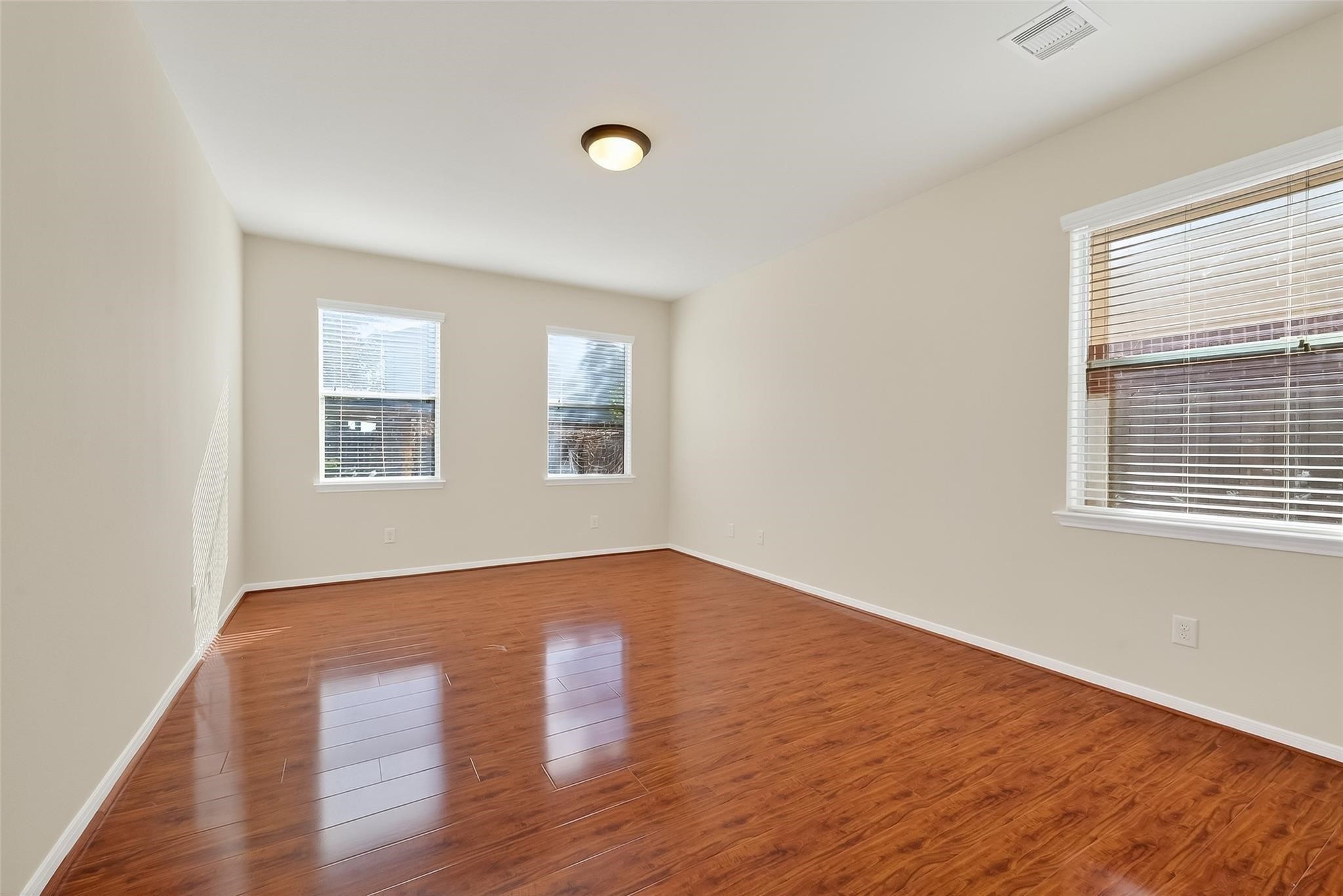 21623 Mid Peak Way Katy, TX 77449 - Photo 30 of 38 an empty room with wooden floor and windows