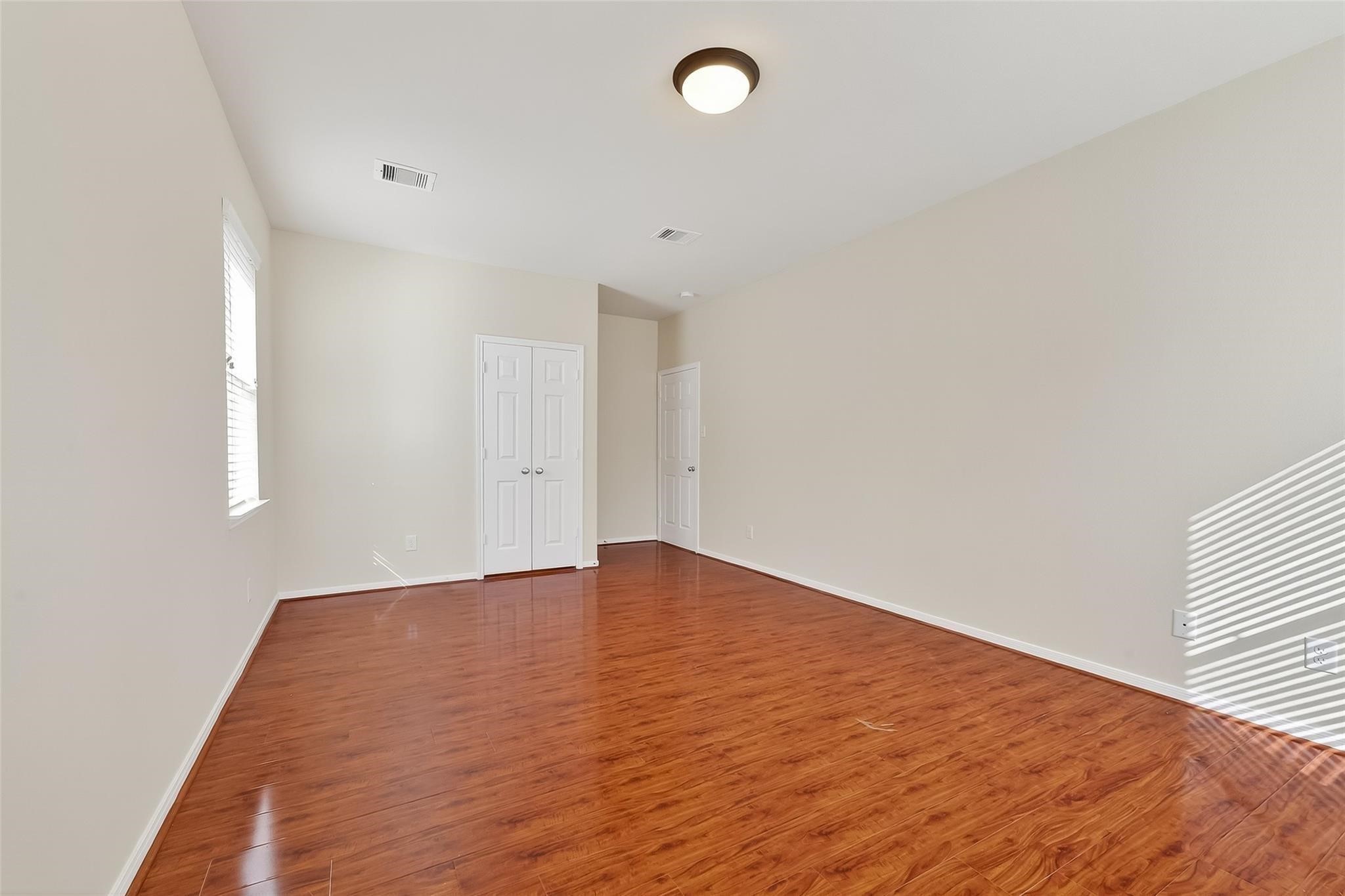 21623 Mid Peak Way Katy, TX 77449 - Photo 31 of 38 an empty room with wooden floor and windows