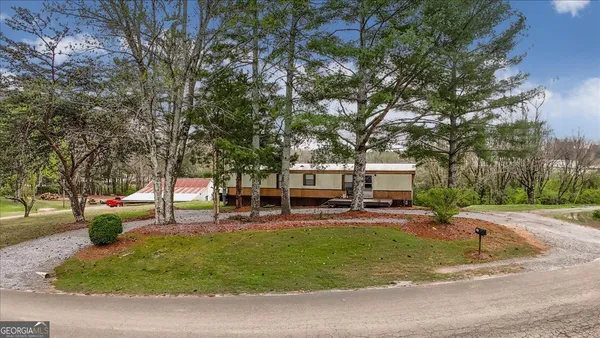 a view of a park with bench and trees