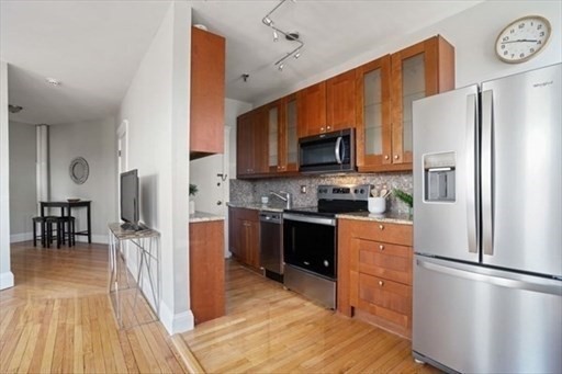 a kitchen with stainless steel appliances a refrigerator stove microwave and sink