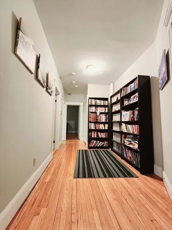 a view of a room with wooden floor and staircase