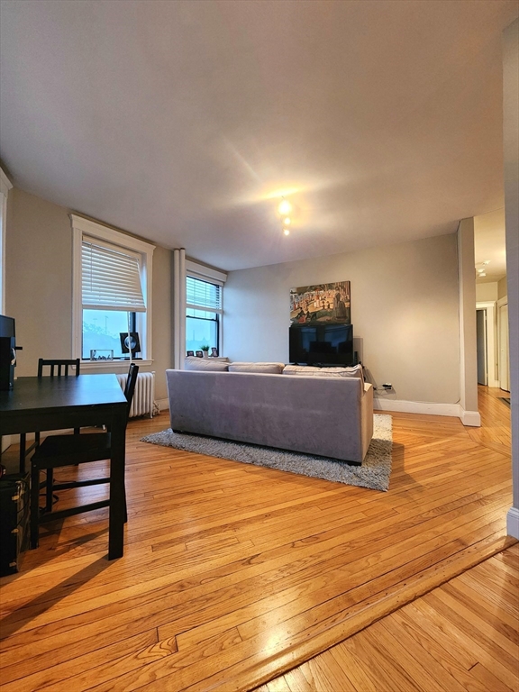2 Sutherland Road, Unit 34 Boston, MA 02135 - Photo 4 of 10 a living room with furniture and a wooden floor