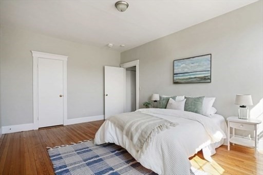 2 Sutherland Road, Unit 34 Boston, MA 02135 - Photo 5 of 10 a bedroom with a bed and wooden floor
