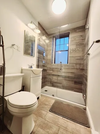 a bathroom with a toilet a sink and bathtub