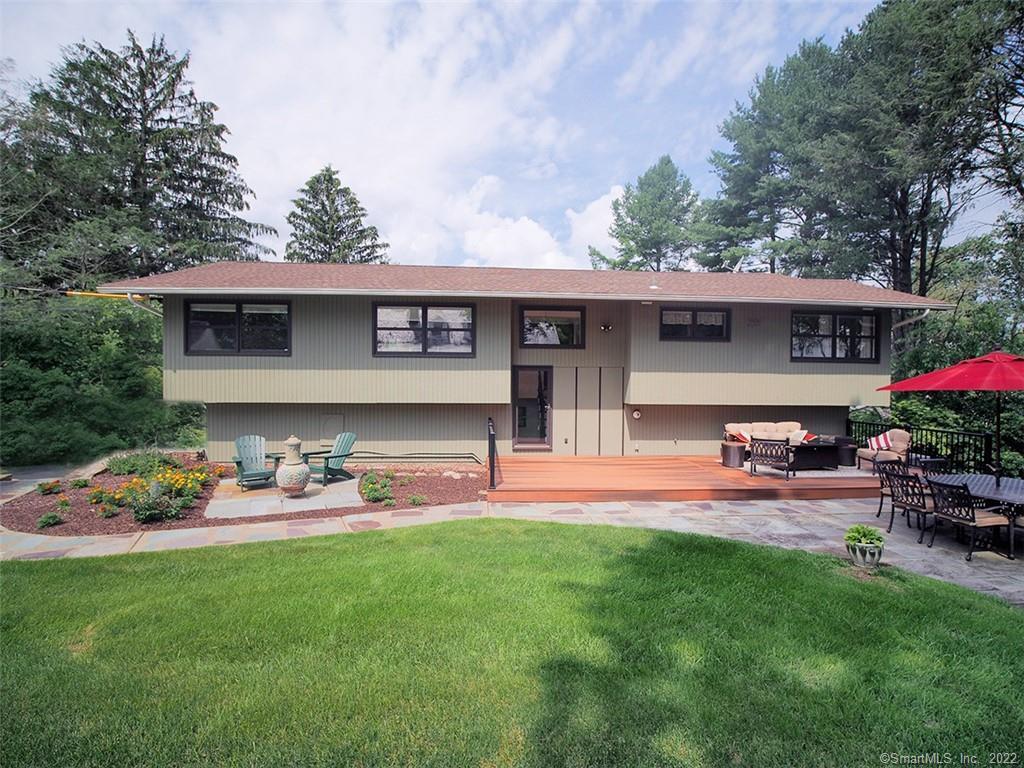 a front view of a house with a garden and sitting area