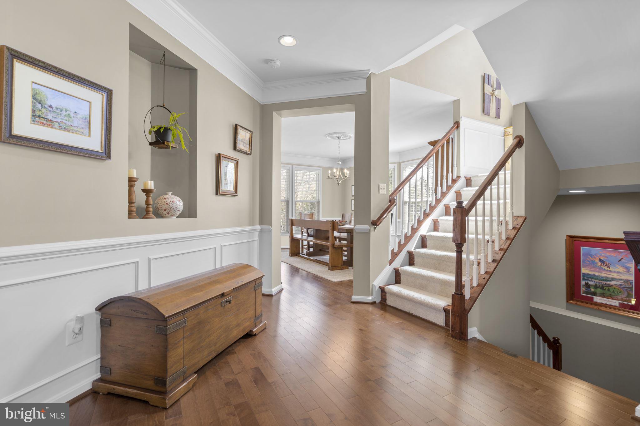 9323 Castle Hill Road Springfield, VA 22153 - Photo 12 of 95 a living room with furniture and stairs with wooden floor