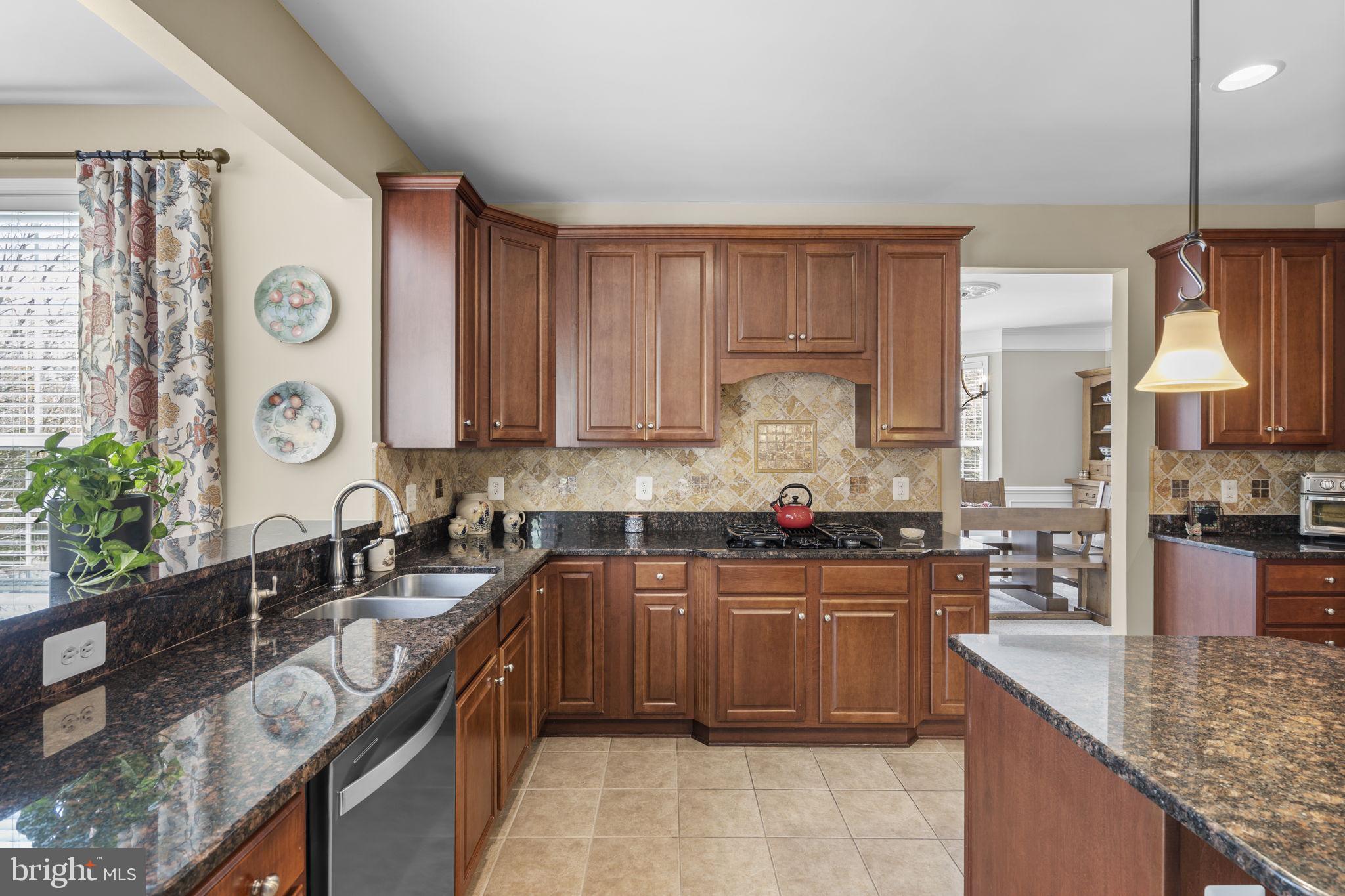 9323 Castle Hill Road Springfield, VA 22153 - Photo 20 of 95 a kitchen with stainless steel appliances granite countertop a sink stove and refrigerator