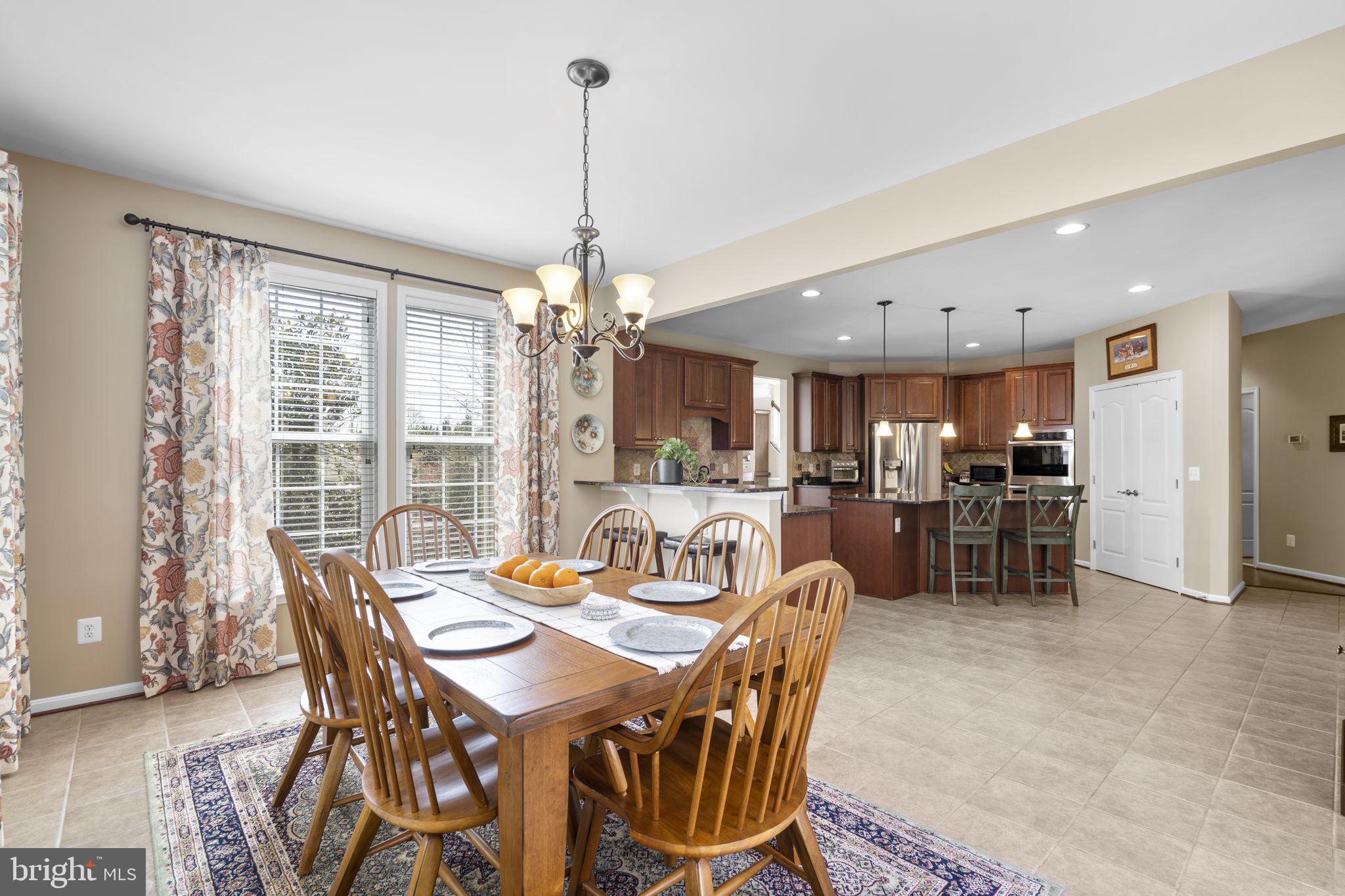 9323 Castle Hill Road Springfield, VA 22153 - Photo 27 of 95 a view of a dining room and livingroom with furniture wooden floor a chandelier