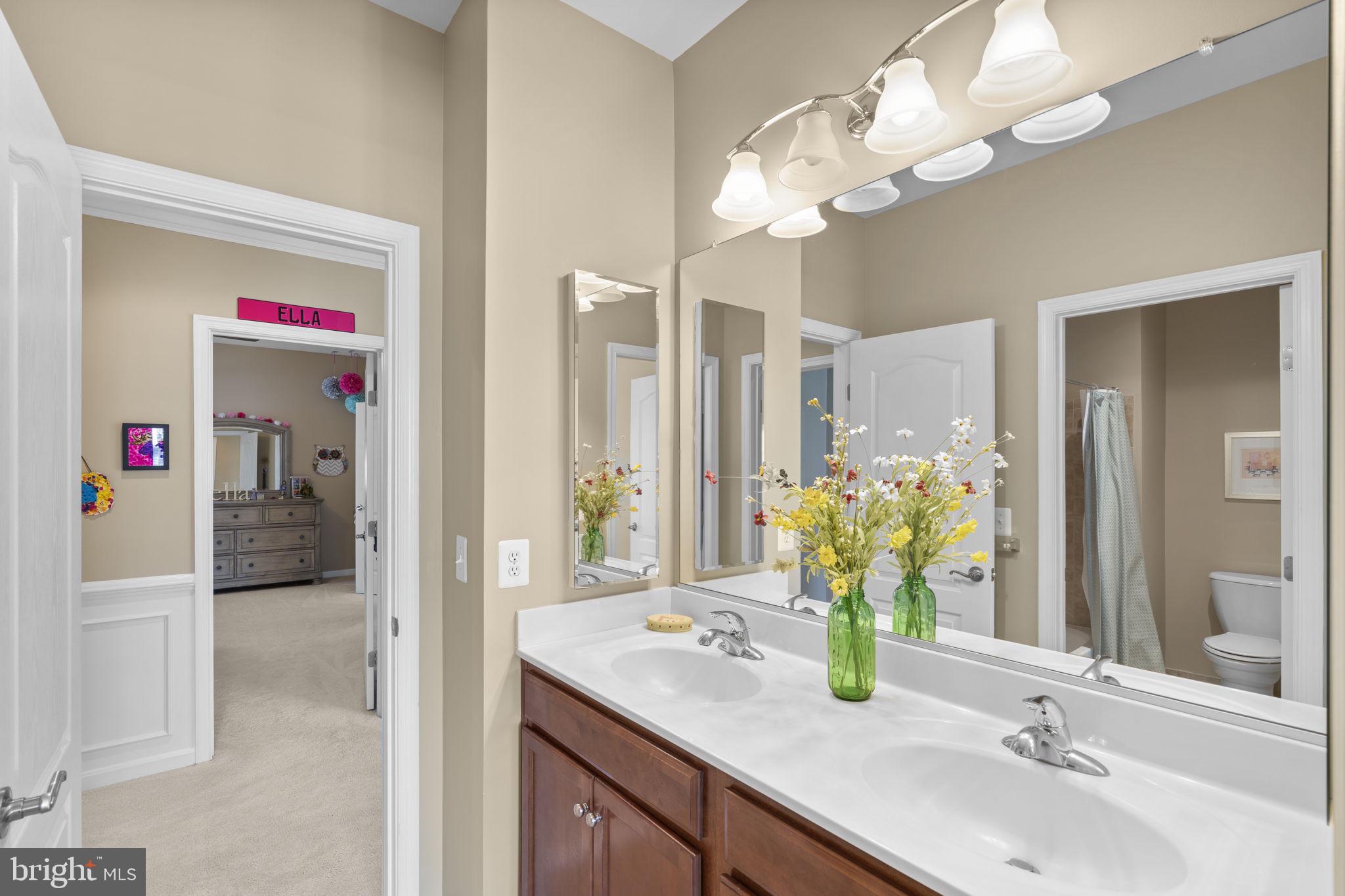 9323 Castle Hill Road Springfield, VA 22153 - Photo 48 of 95 a bathroom with a sink vanity and a mirror