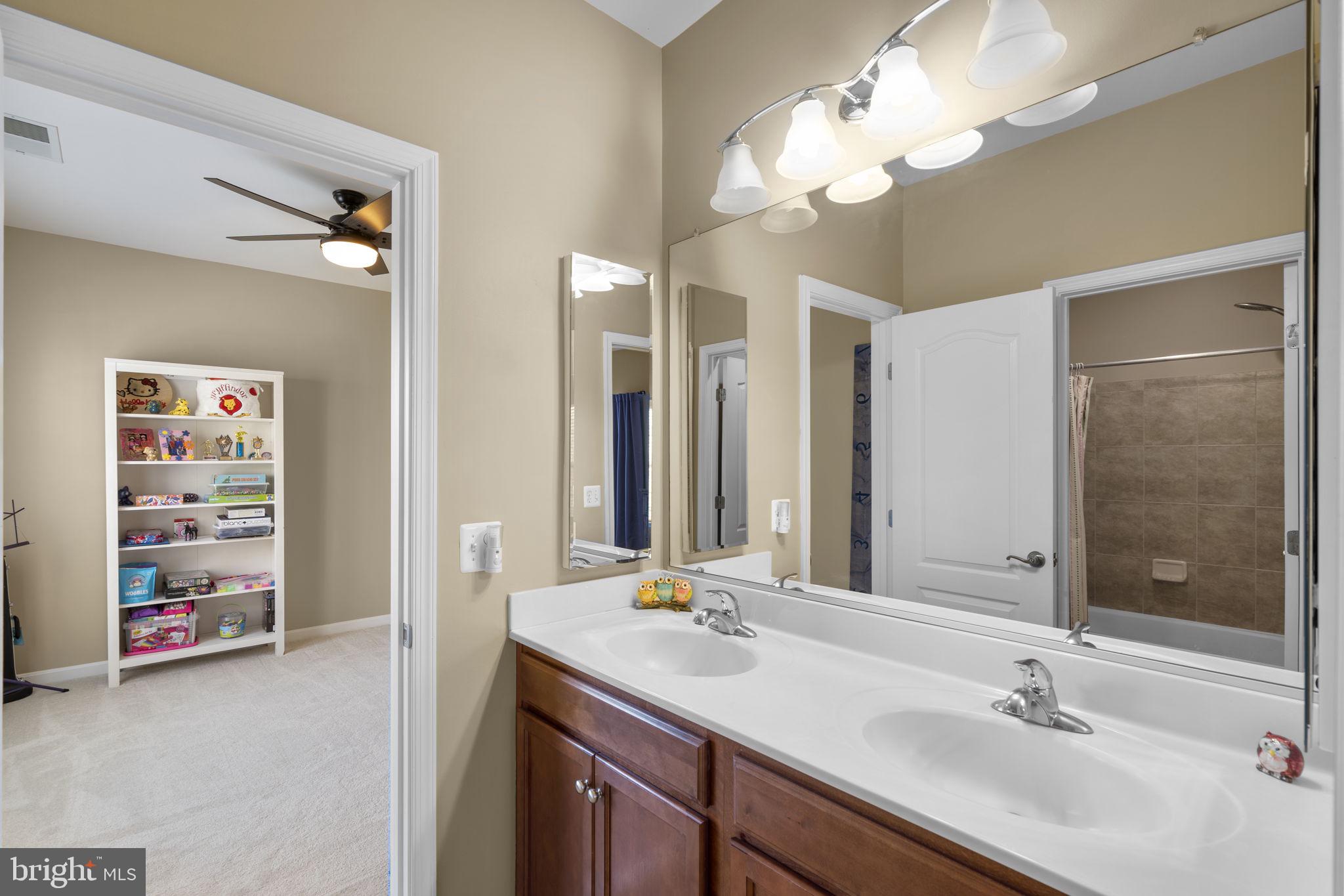 9323 Castle Hill Road Springfield, VA 22153 - Photo 53 of 95 a bathroom with a double vanity sink and a mirror