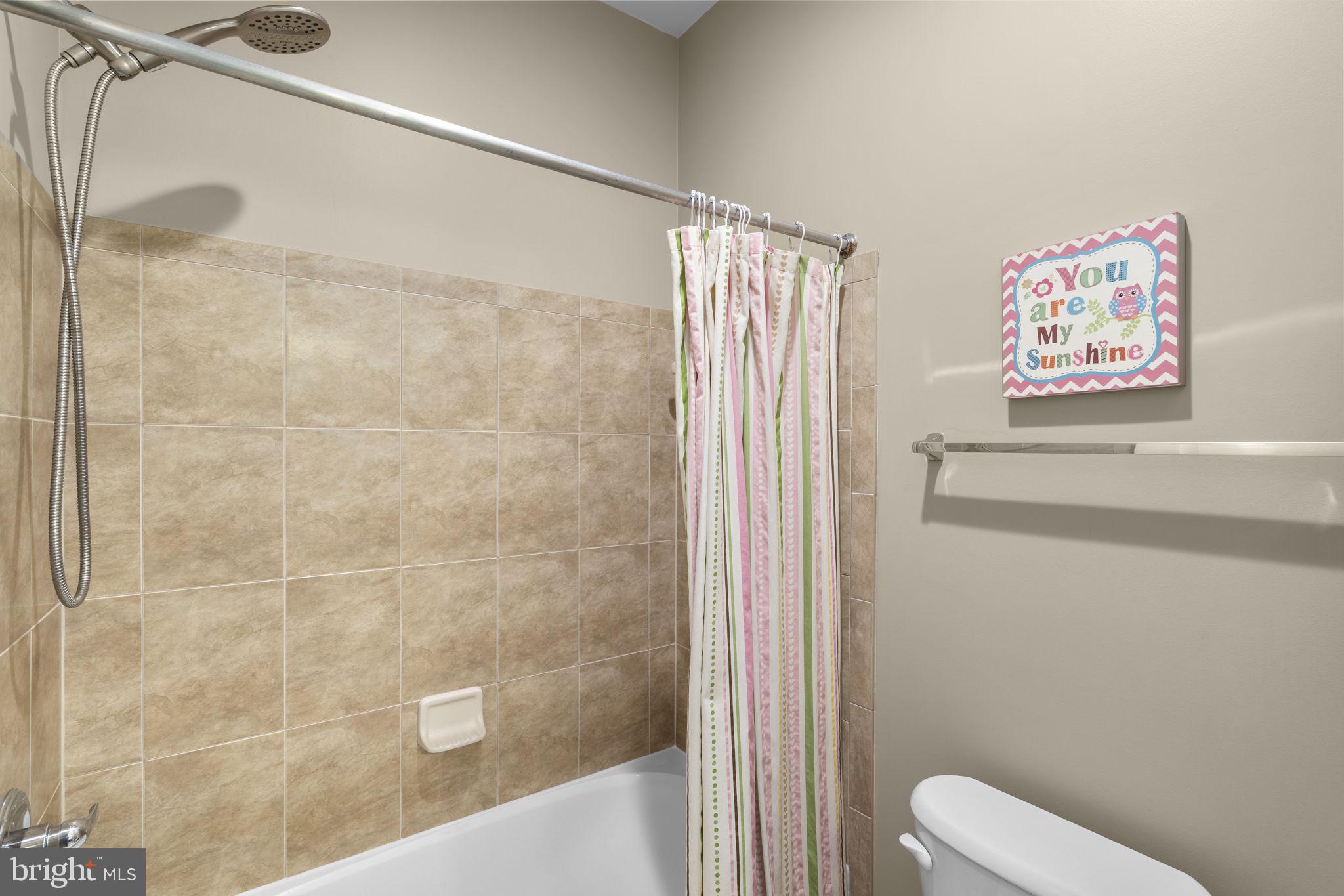 9323 Castle Hill Road Springfield, VA 22153 - Photo 54 of 95 a bathroom with a shower and toilet