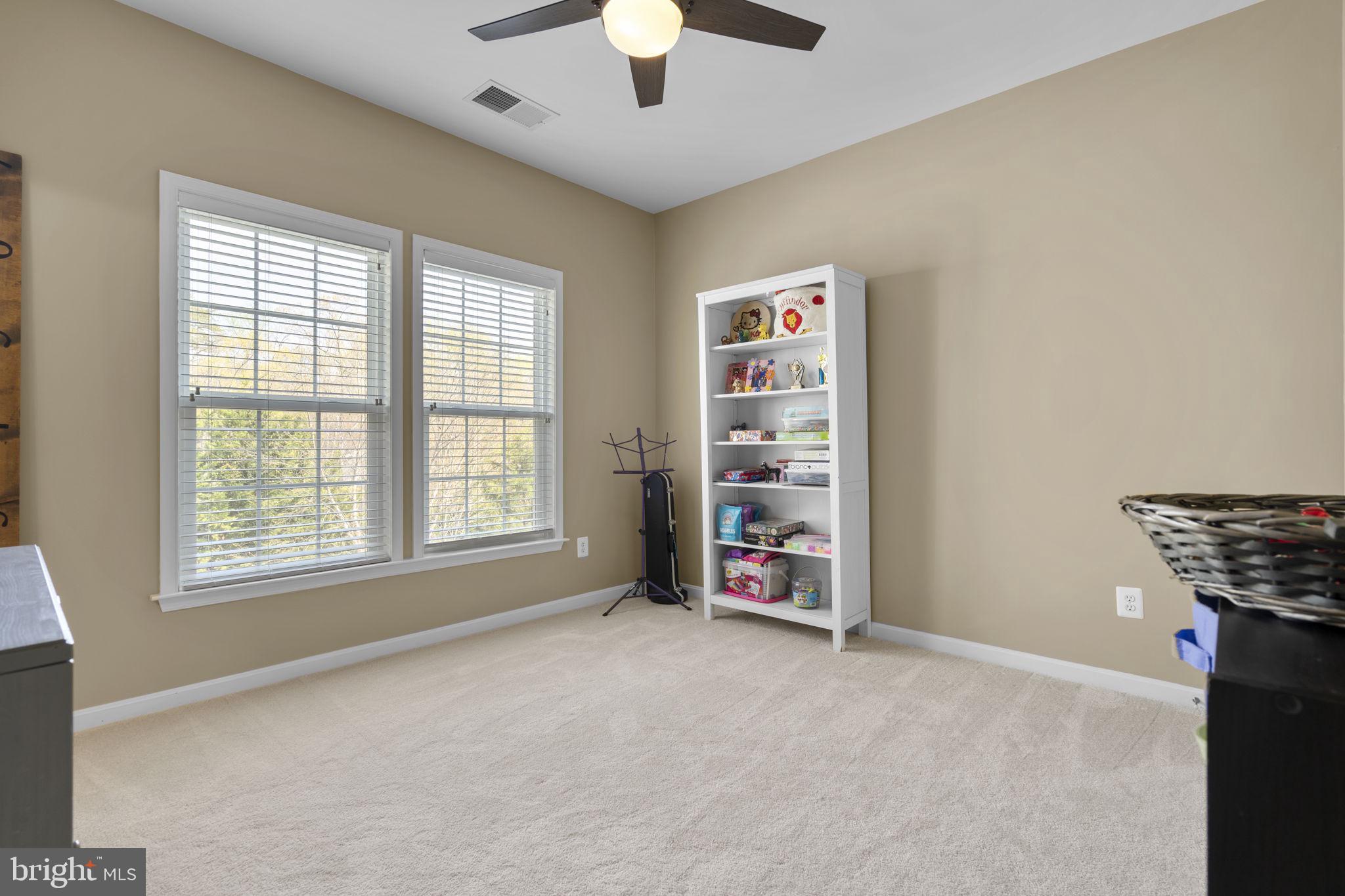 9323 Castle Hill Road Springfield, VA 22153 - Photo 55 of 95 an empty room with chandelier fan and windows