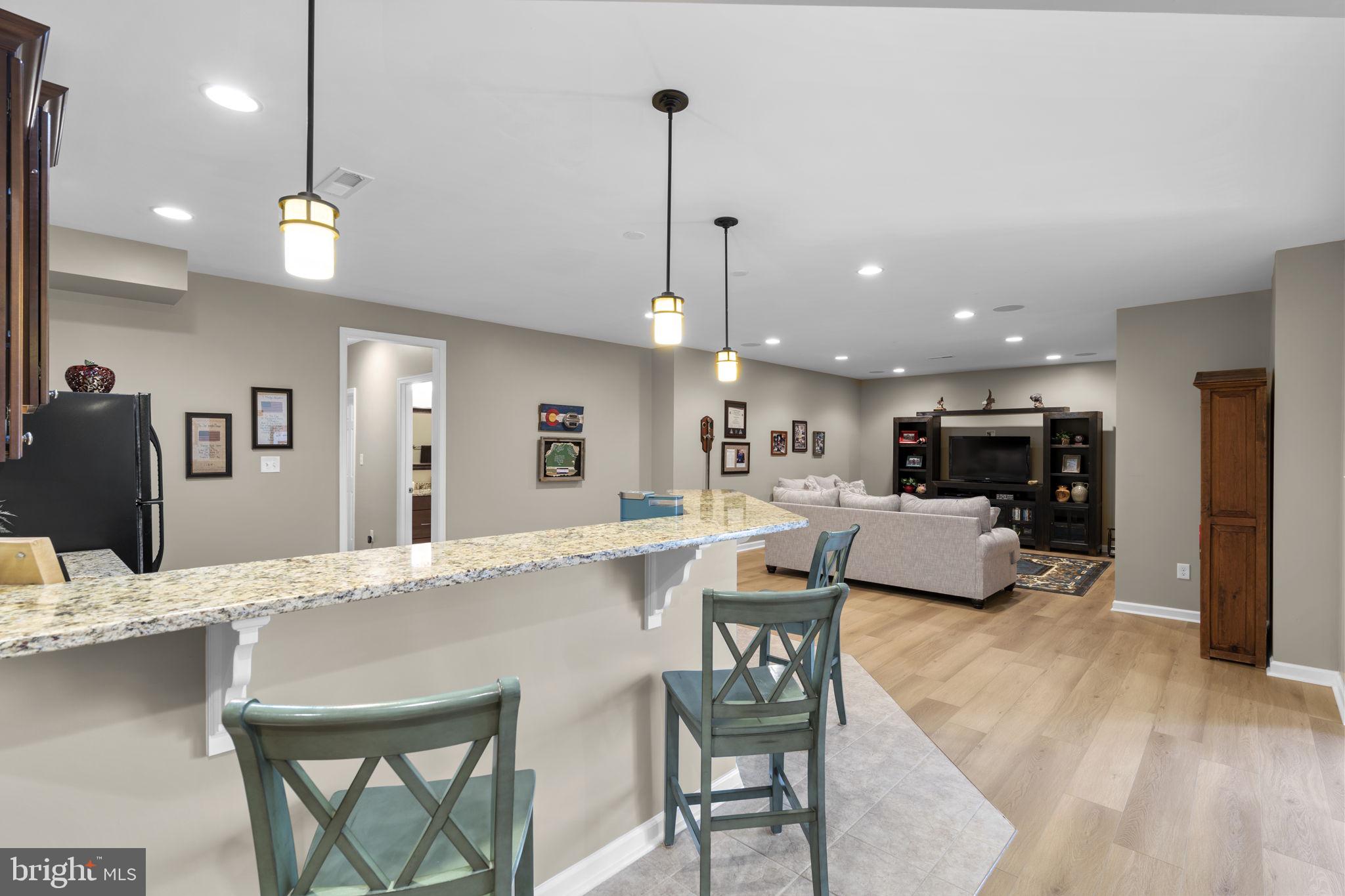 9323 Castle Hill Road Springfield, VA 22153 - Photo 64 of 95 a view of a dining room and livingroom with furniture wooden floor a chandelier