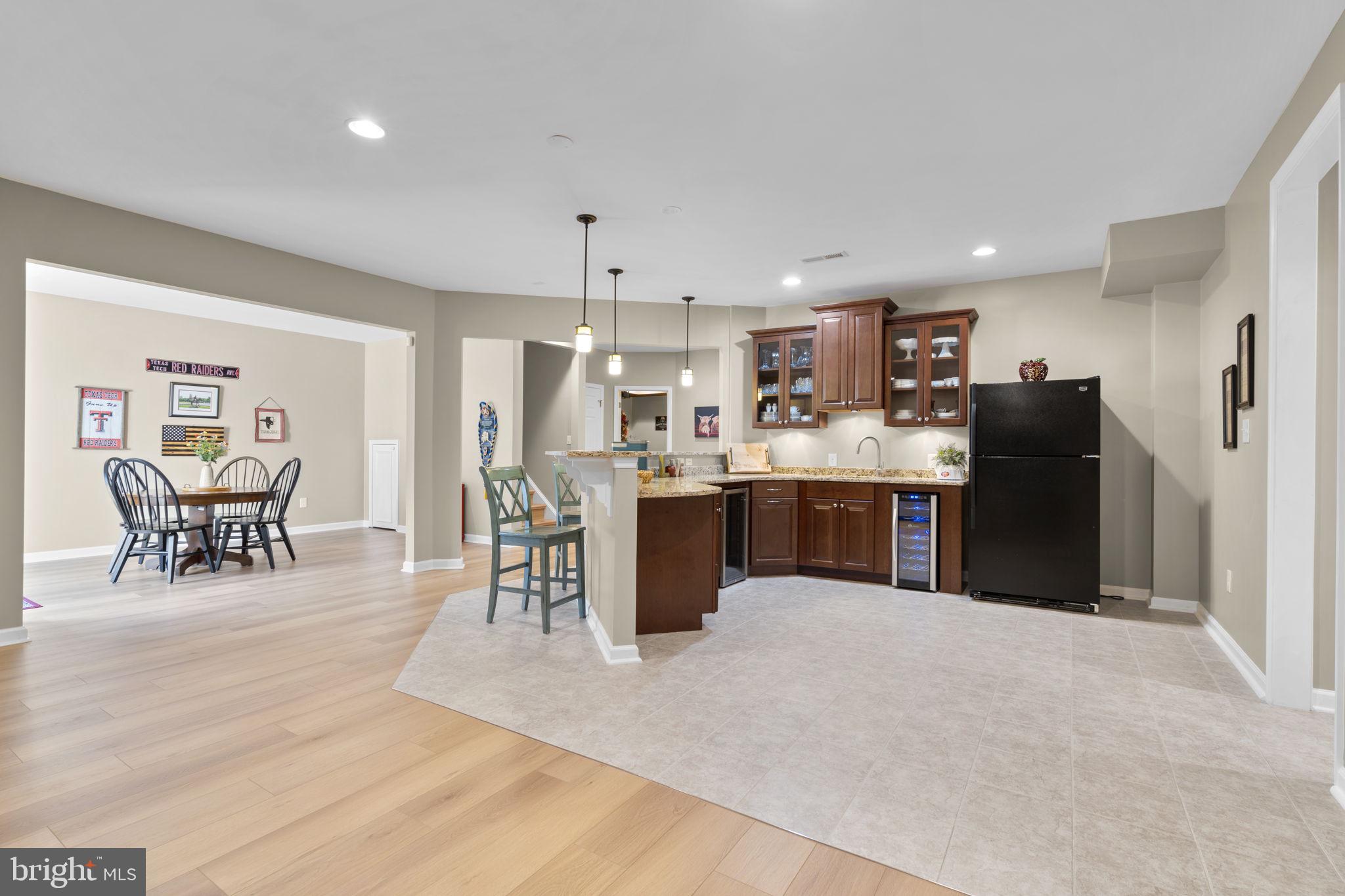 9323 Castle Hill Road Springfield, VA 22153 - Photo 66 of 95 a kitchen with stainless steel appliances kitchen island granite countertop a refrigerator and a dining table