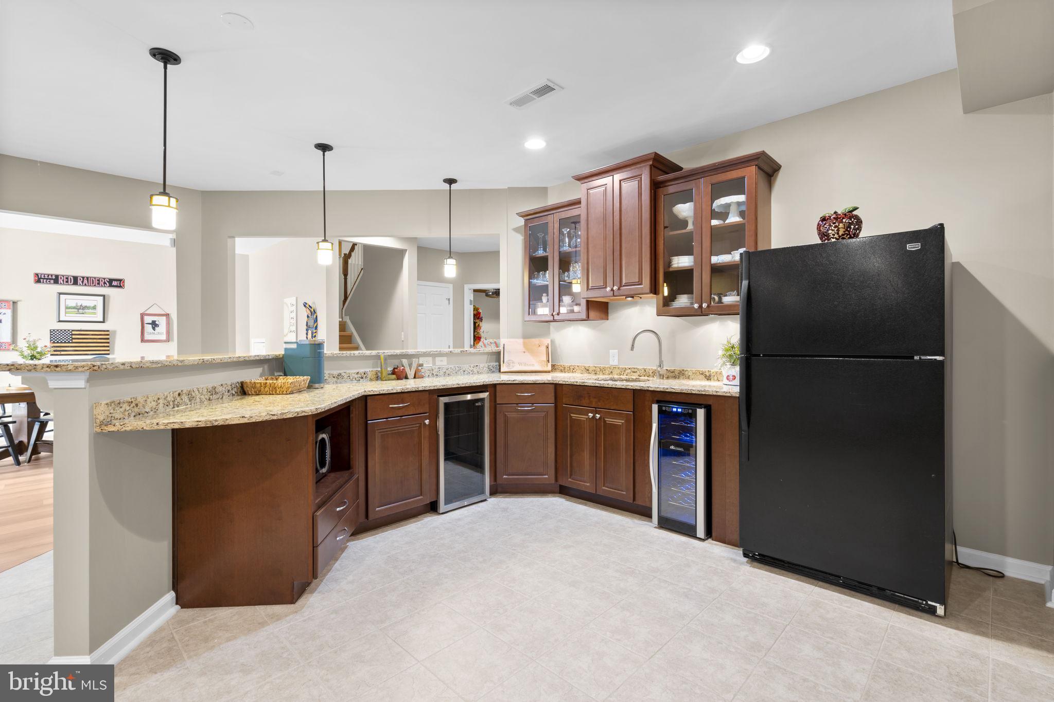 9323 Castle Hill Road Springfield, VA 22153 - Photo 67 of 95 a kitchen with stainless steel appliances granite countertop a refrigerator a sink dishwasher a stove and a refrigerator