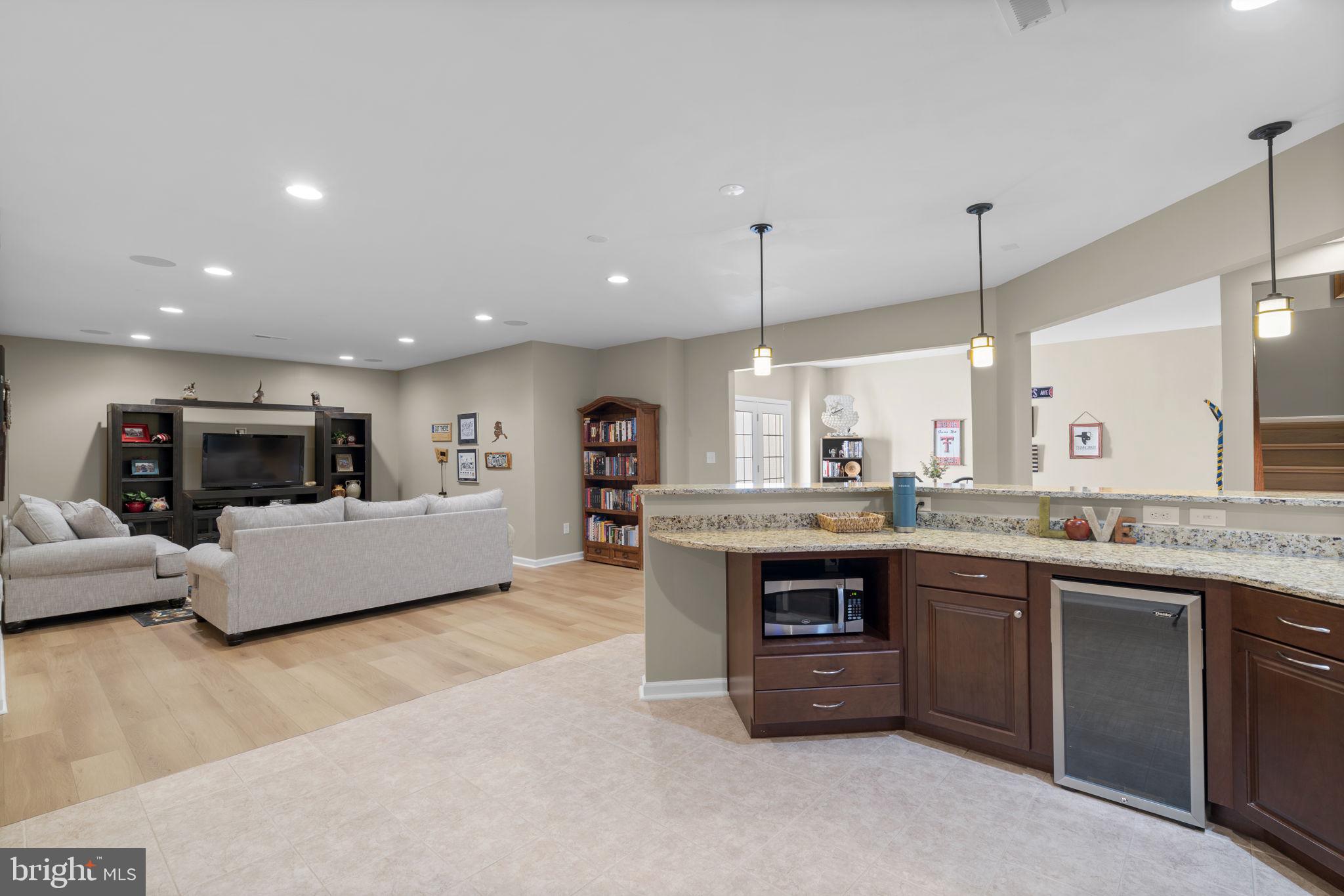 9323 Castle Hill Road Springfield, VA 22153 - Photo 68 of 95 a large kitchen with kitchen island a sink a stove a dining table and chairs